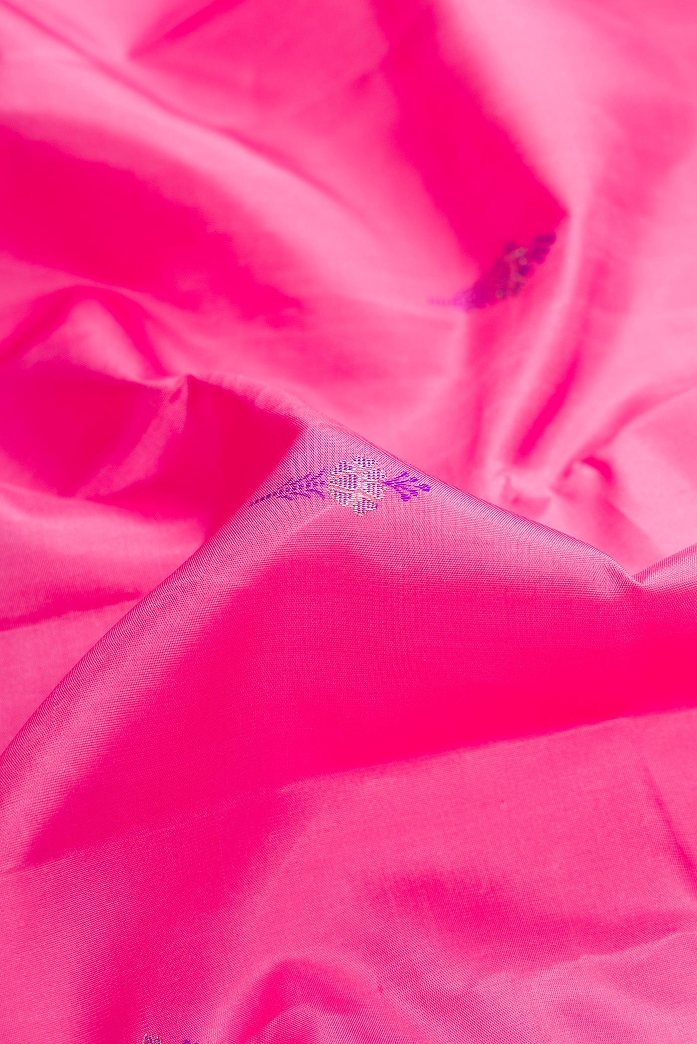 Close up of Pure Silk Pure Zari Pink Dual Tone Kanjivaram Saree with Zari Butta on the body and Fancy Border.  displaying folds