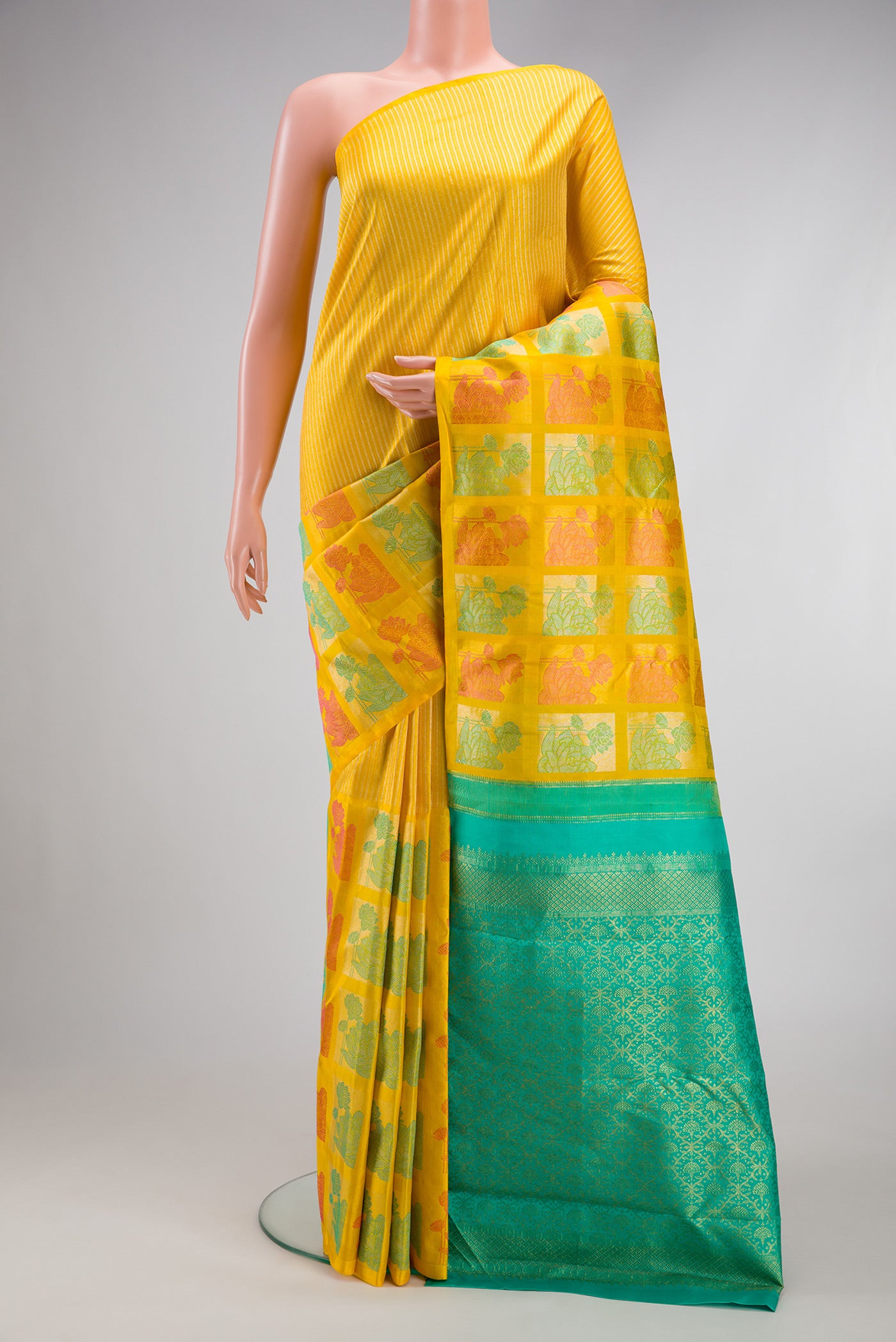 Yellow Kanjivaram Silk Saree with Stripes on the body and Fancy Border.  displayed on a mannequin