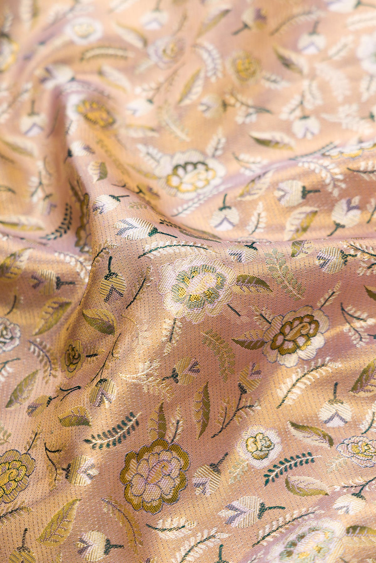 Close up of Gold Dual Tone Kanchipuram Tissue Silk Saree with Zari Brocade on the body and Fancy Border.  displaying folds