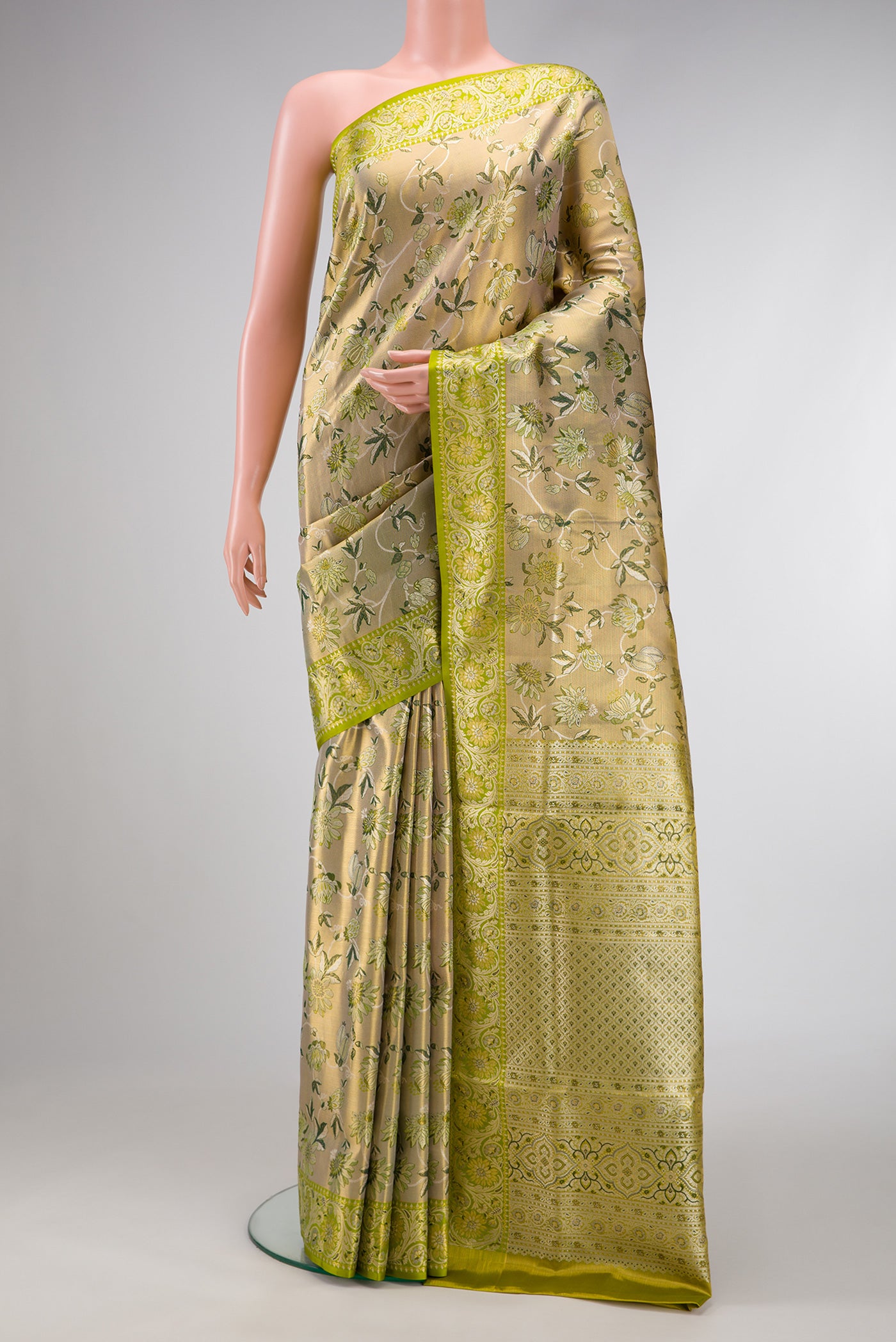Pista Green Dual Tone Kanchipuram Tissue Silk Saree with Zari Brocade on the body and Fancy Border.  displayed on a mannequin