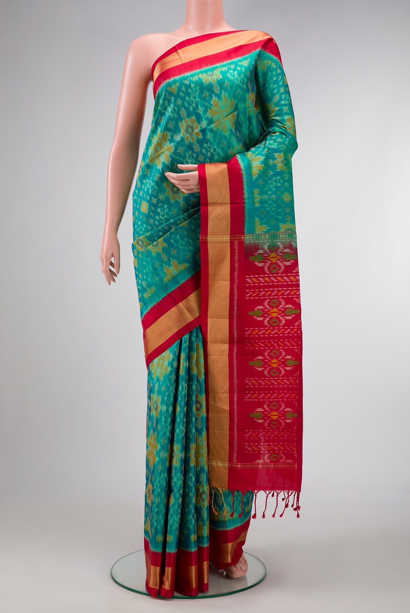 Sea Green Dual Tone Soft Silk Saree with Ikat Print on the body and Zari Border.  displayed on a mannequin
