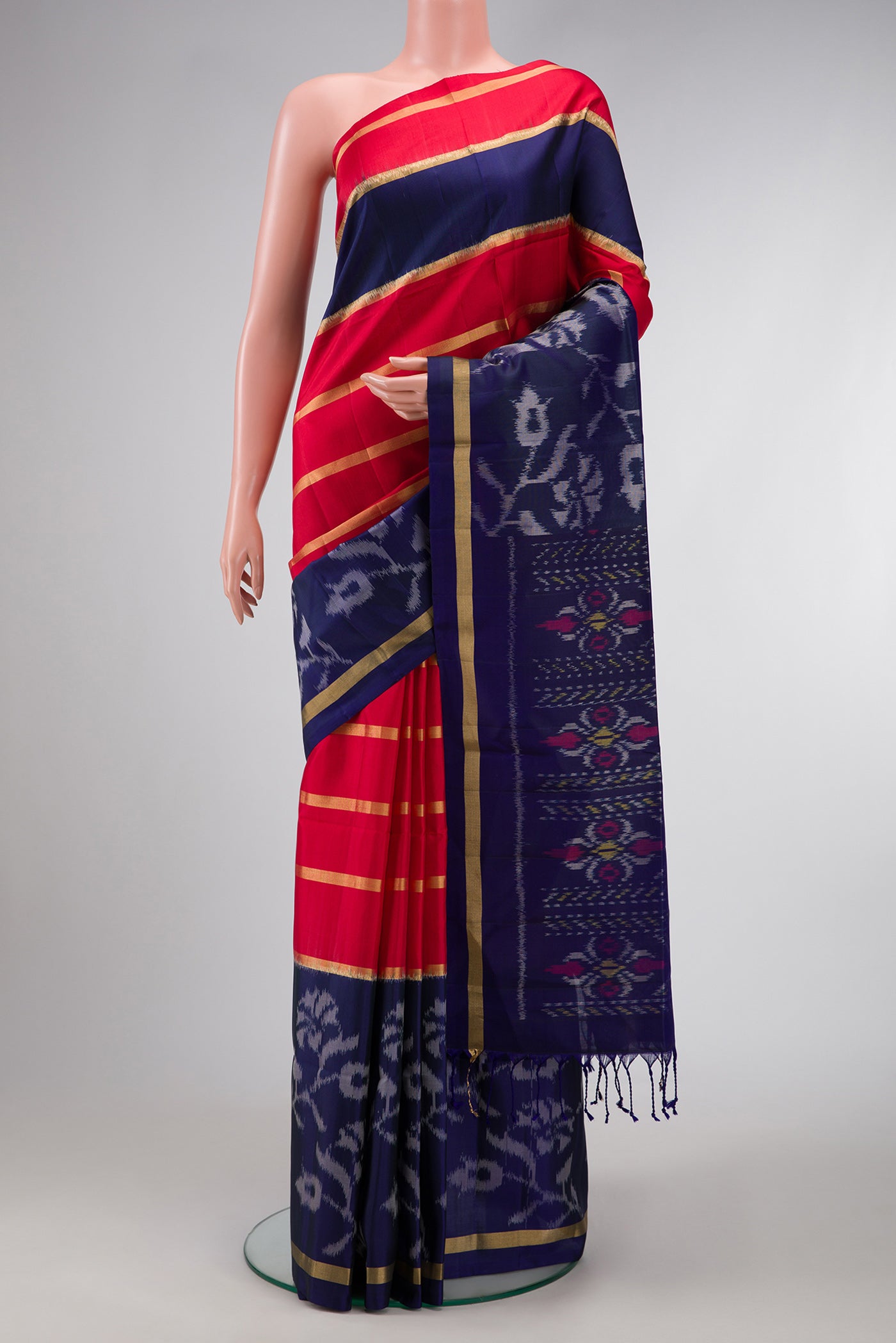 Red Dual Tone Soft Silk Saree with Stripes on the body and Ikat Border.  displayed on a mannequin