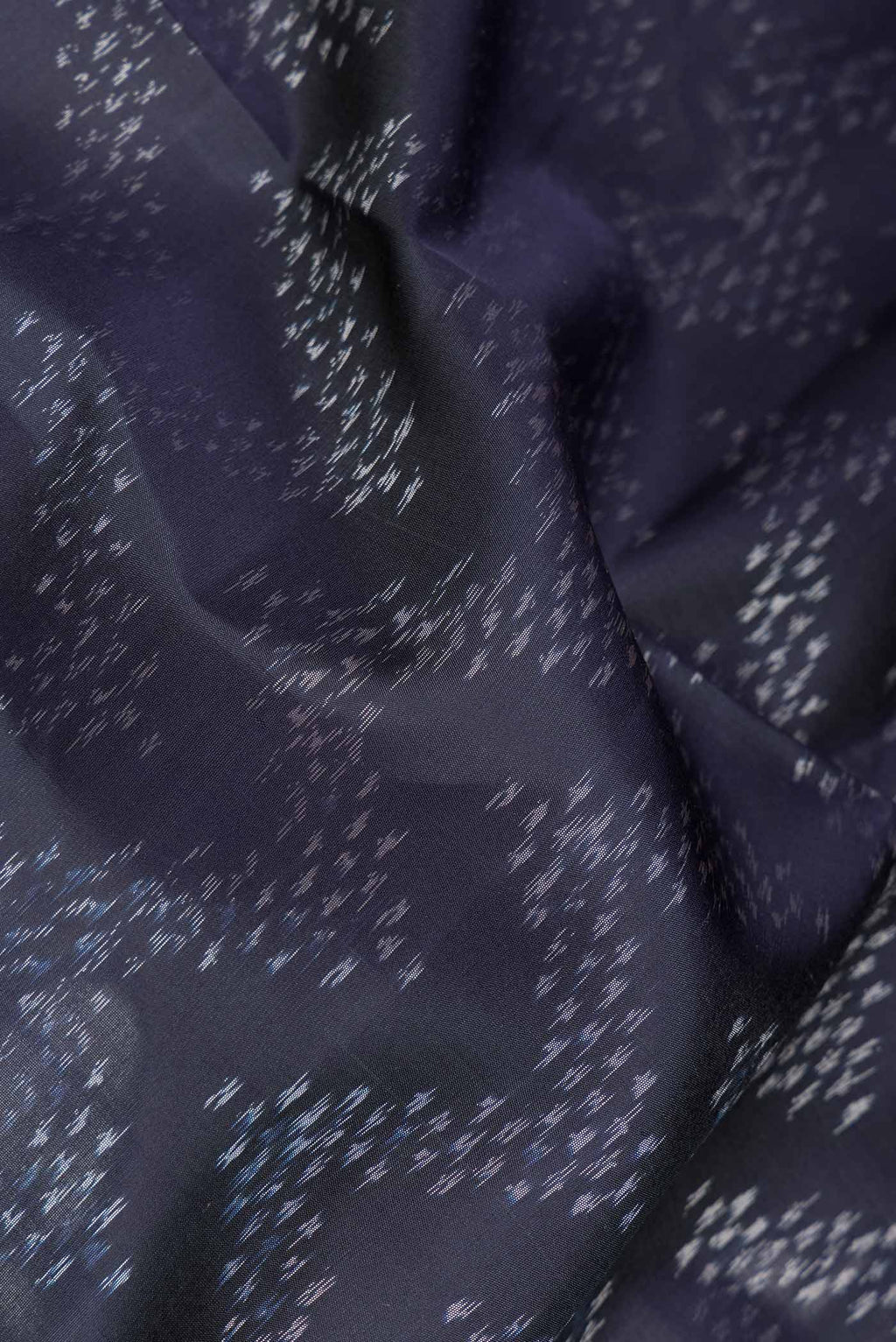 Close up of Navy Blue Dual Tone Soft Silk Saree with Ikat Print on the body and Ikat Border.  displaying folds