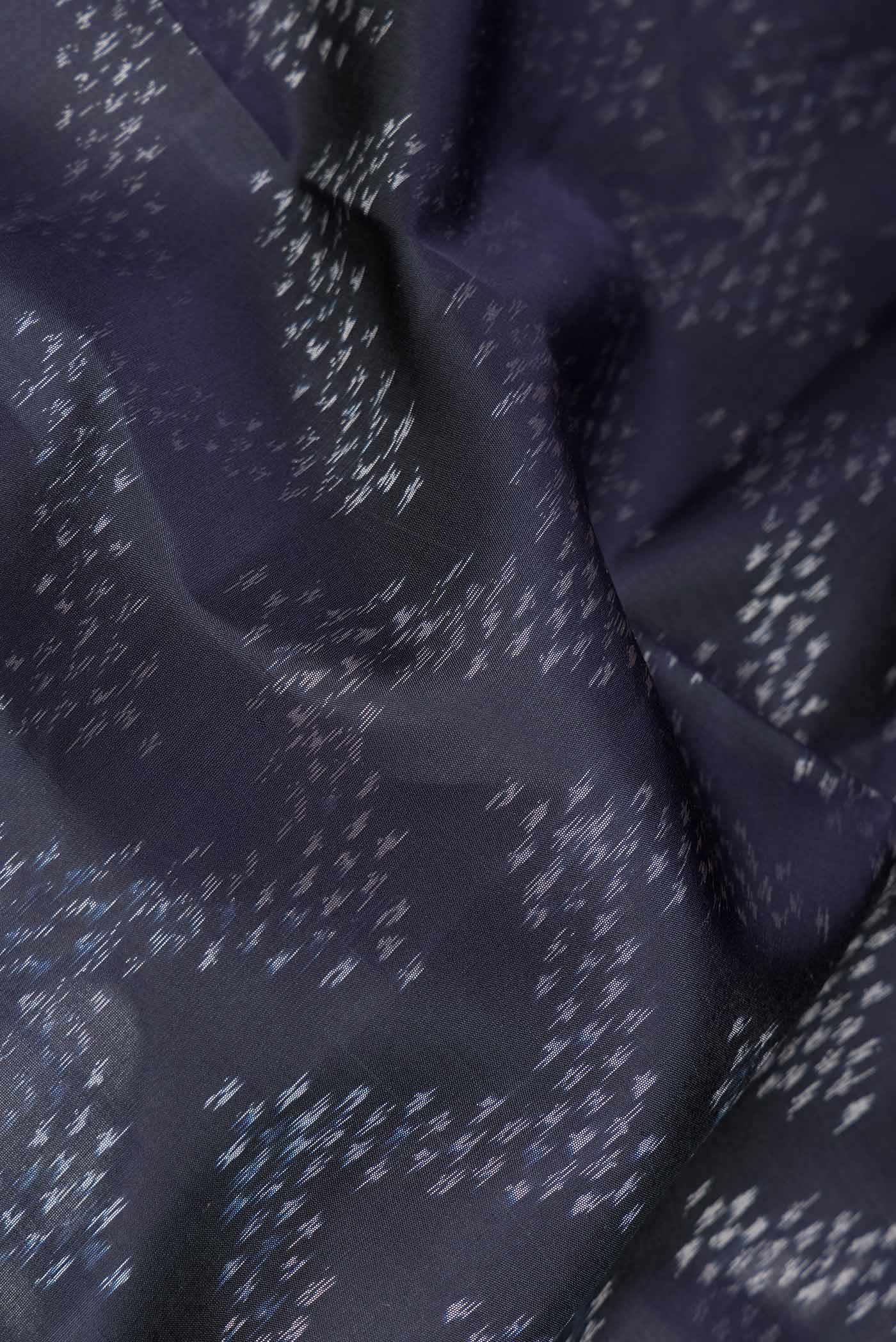 Close up of Navy Blue Dual Tone Soft Silk Saree with Ikat Print on the body and Ikat Border.  displaying folds