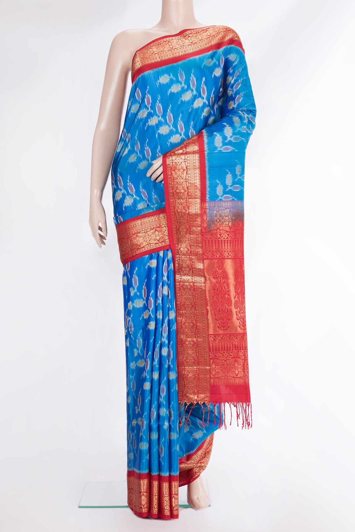 Pure Silk Peacock Blue Dual Tone Soft Saree with Ikat Print on the body and Zari Border.  displayed on a mannequin