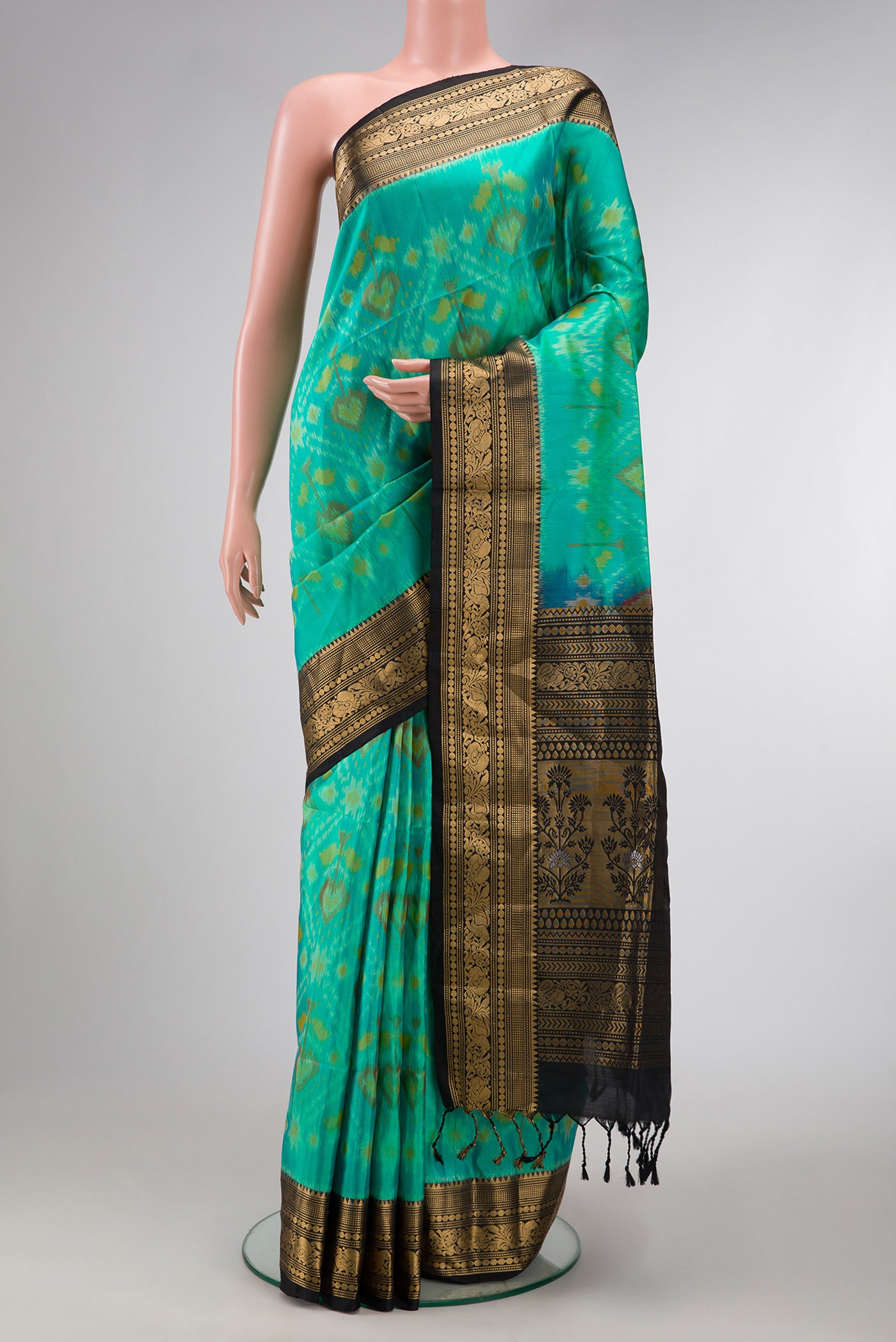 Sea Green Dual Tone Soft Silk Saree with Ikat Print on the body and Zari Border.  displayed on a mannequin