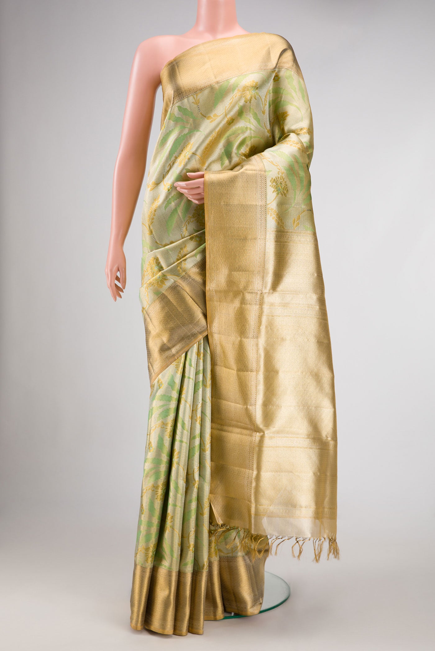 Pista Green Dual Tone Kanjivaram Tissue Silk Saree with Zari Brocade on the body and Zari Border.  displayed on a mannequin
