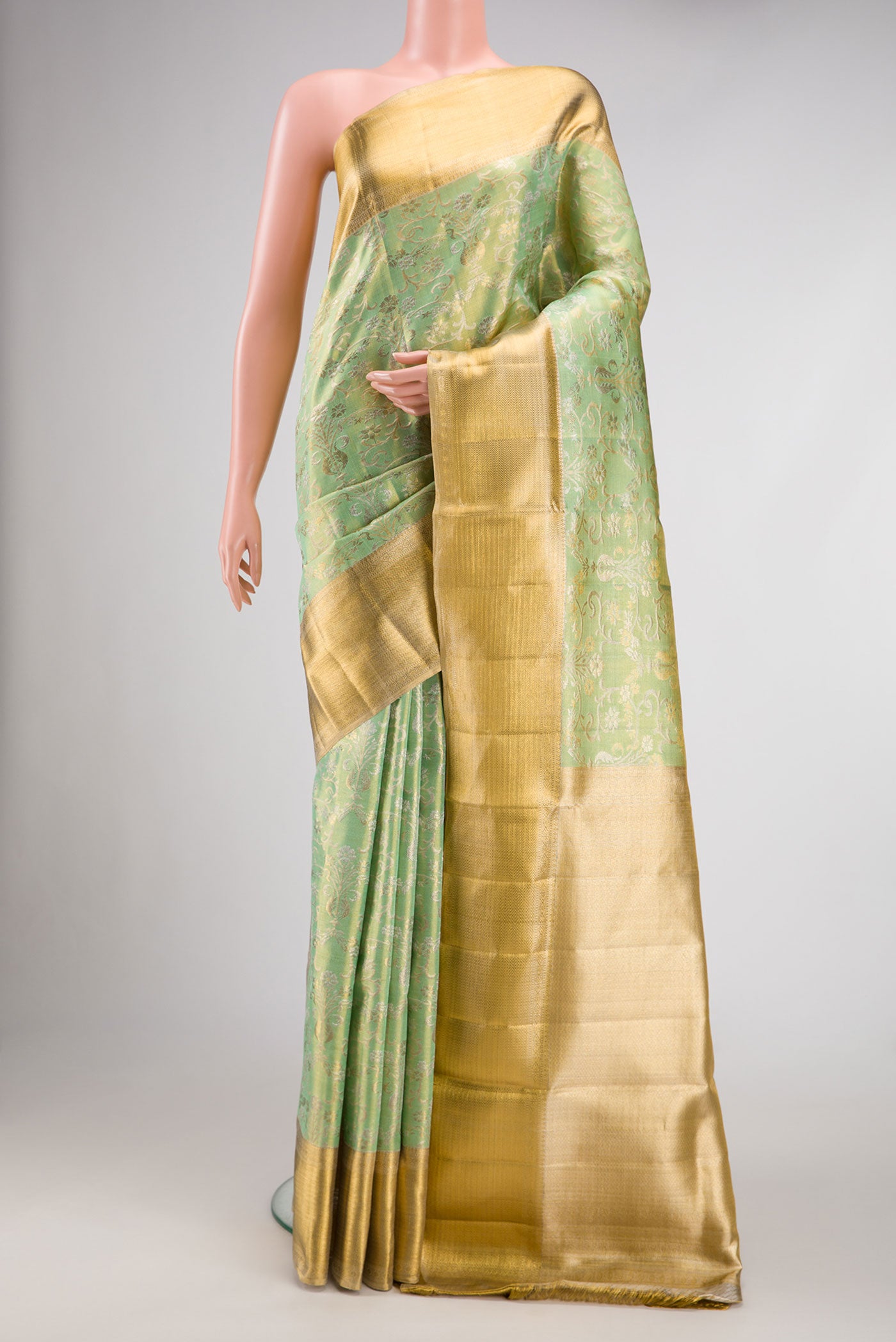 Sea Green Dual Tone Kanjivaram Tissue Silk Saree with Zari Brocade on the body and Zari Border.  displayed on a mannequin