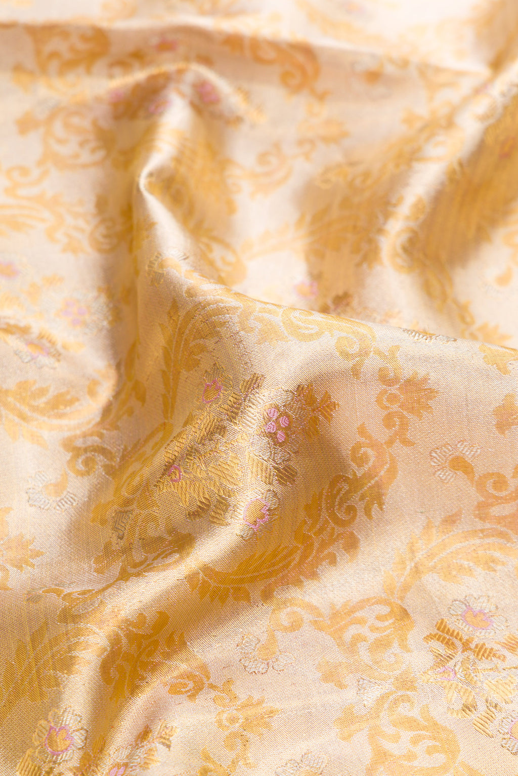 Close up of Gold Dual Tone Kanjivaram Tissue Silk Saree with Zari Brocade on the body and Fancy Border.  displaying folds