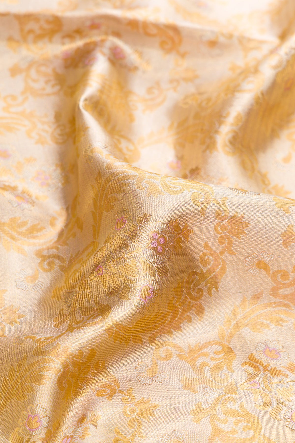 Close up of Gold Dual Tone Kanjivaram Tissue Silk Saree with Zari Brocade on the body and Fancy Border.  displaying folds