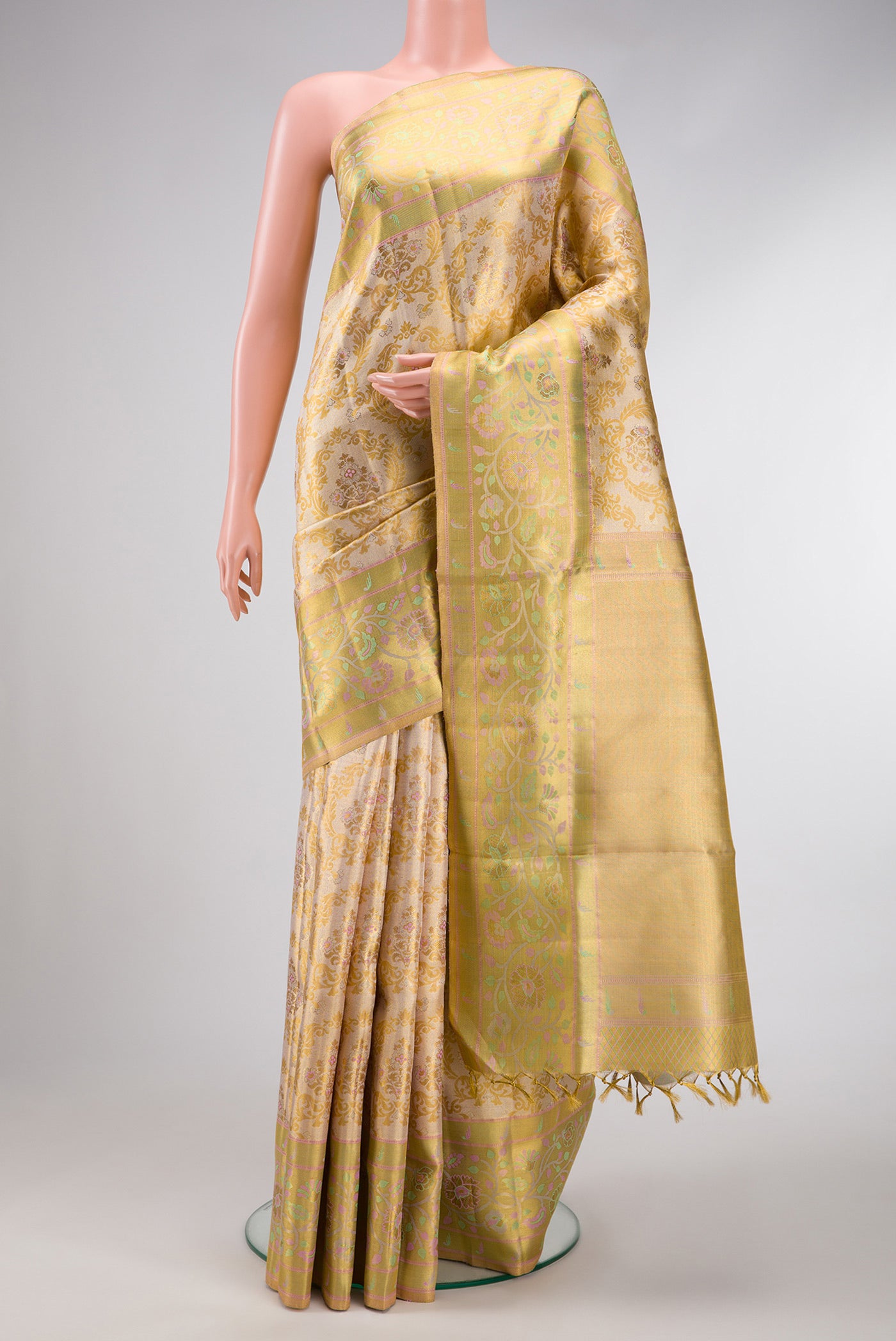 Gold Dual Tone Kanjivaram Tissue Silk Saree with Zari Brocade on the body and Fancy Border.  displayed on a mannequin