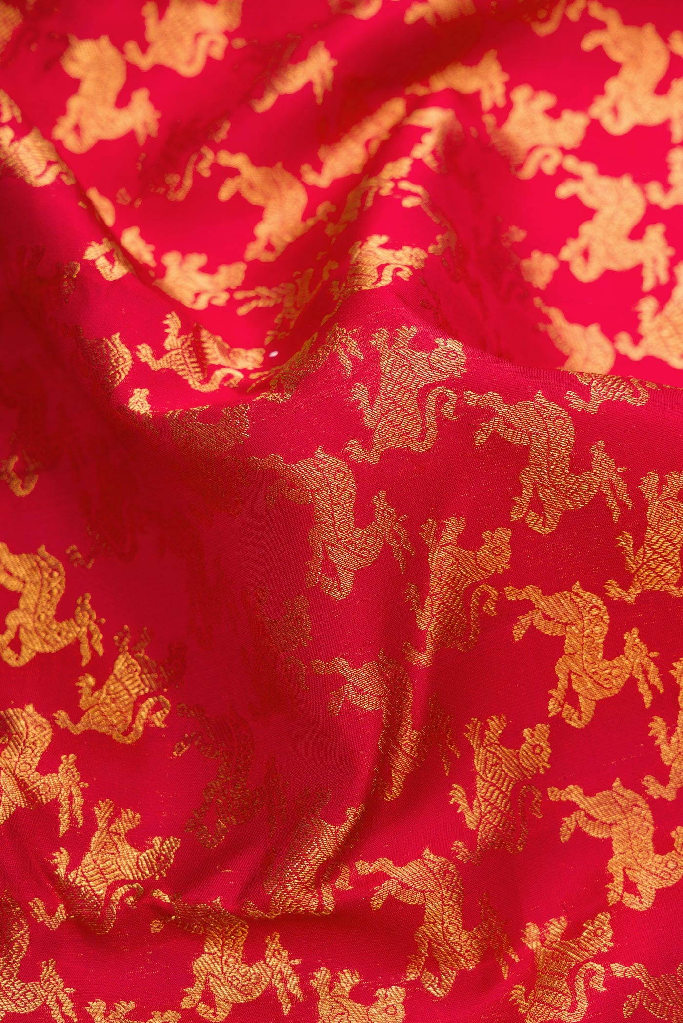 Close up of Red Dual Tone Kanchipuram Silk Saree with Zari Brocade on the body and Zari Border.  displaying folds
