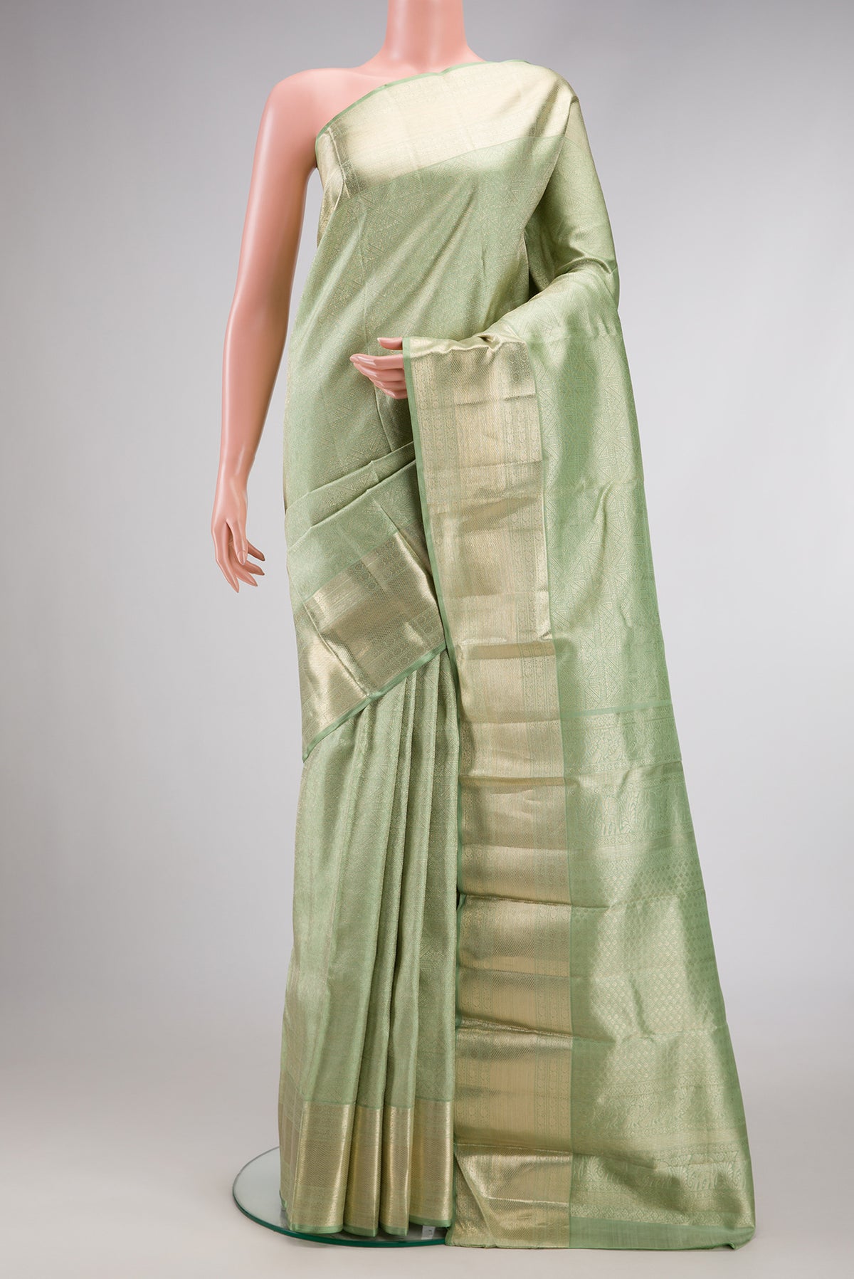 Light Green Dual Tone Kanchipuram Silk Saree with Zari Brocade on the body and Zari Border.  displayed on a mannequin