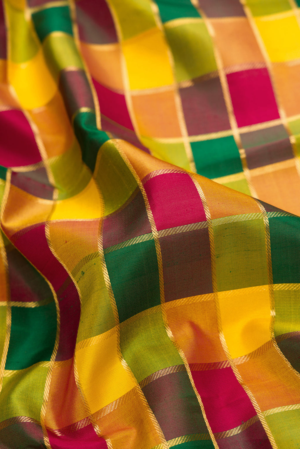 Close up of Pure Silk Pure Zari Maroon, Green and Yellow Color Kanchipuram Saree with Checked design on the body and Zari Border.  displaying folds