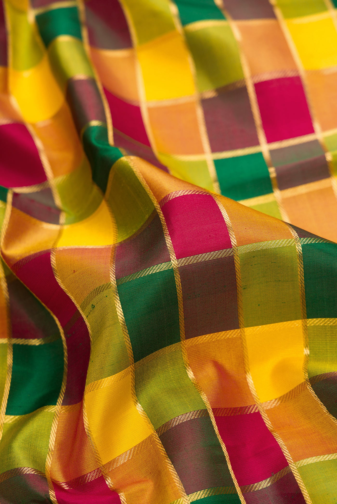 Close up of Pure Silk Pure Zari Maroon, Green and Yellow Color Kanchipuram Saree with Checked design on the body and Zari Border.  displaying folds