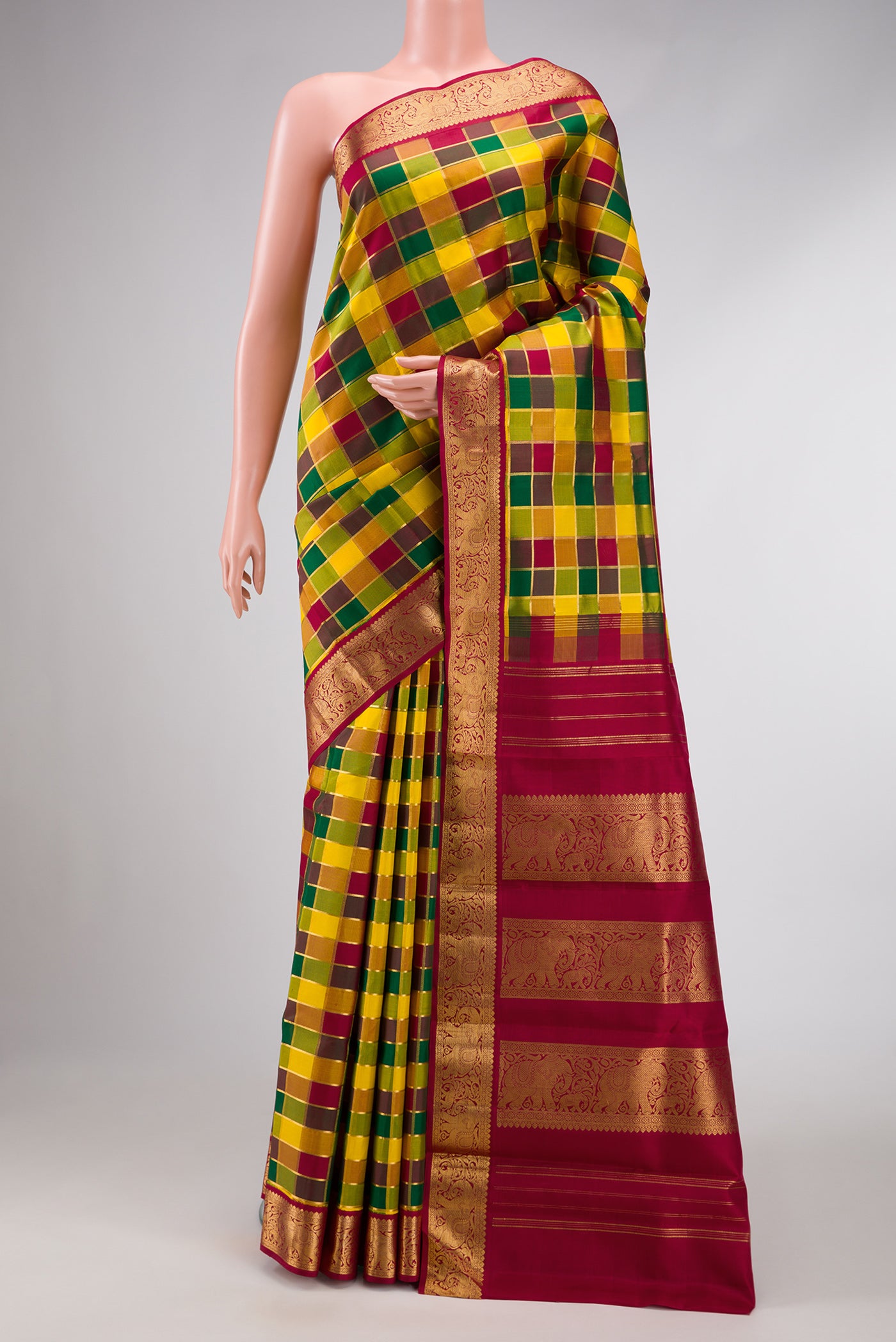Pure Silk Pure Zari Maroon, Green and Yellow Color Kanchipuram Saree with Checked design on the body and Zari Border.  displayed on a mannequin
