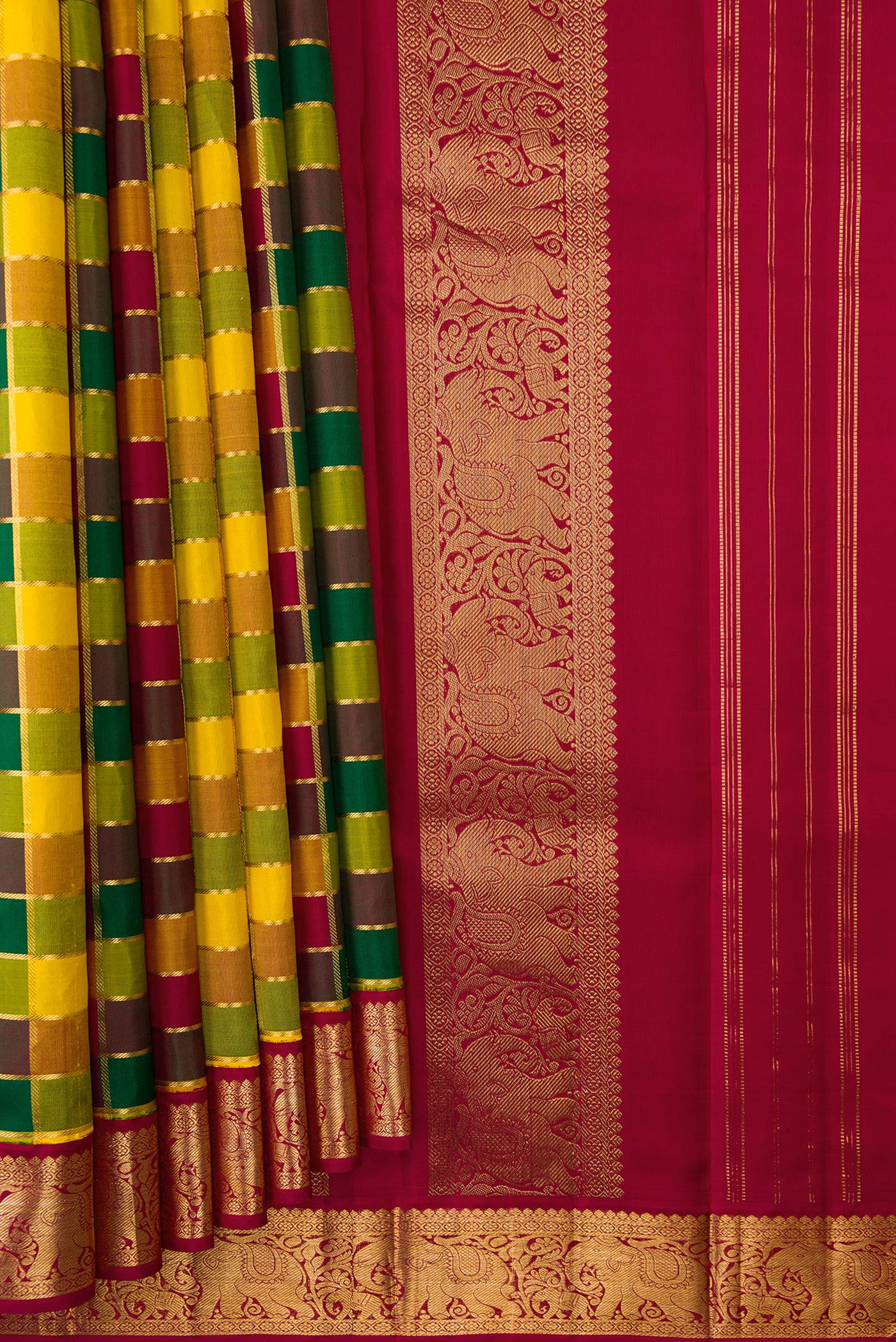 Pleats and pallu of Pure Silk Pure Zari Maroon, Green and Yellow Color Kanchipuram Saree with Checked design on the body and Zari Border. 