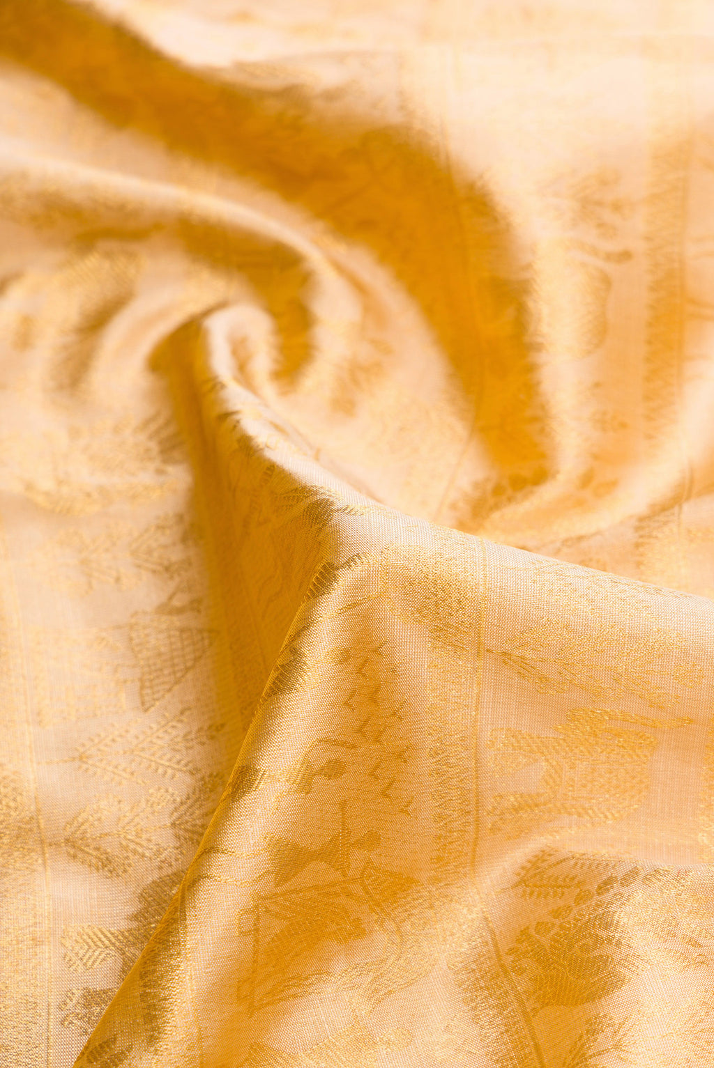 Close up of Rose Gold Dual Tone Kanchipuram Silk Saree with Zari Brocade on the body and Fancy Border.  displaying folds