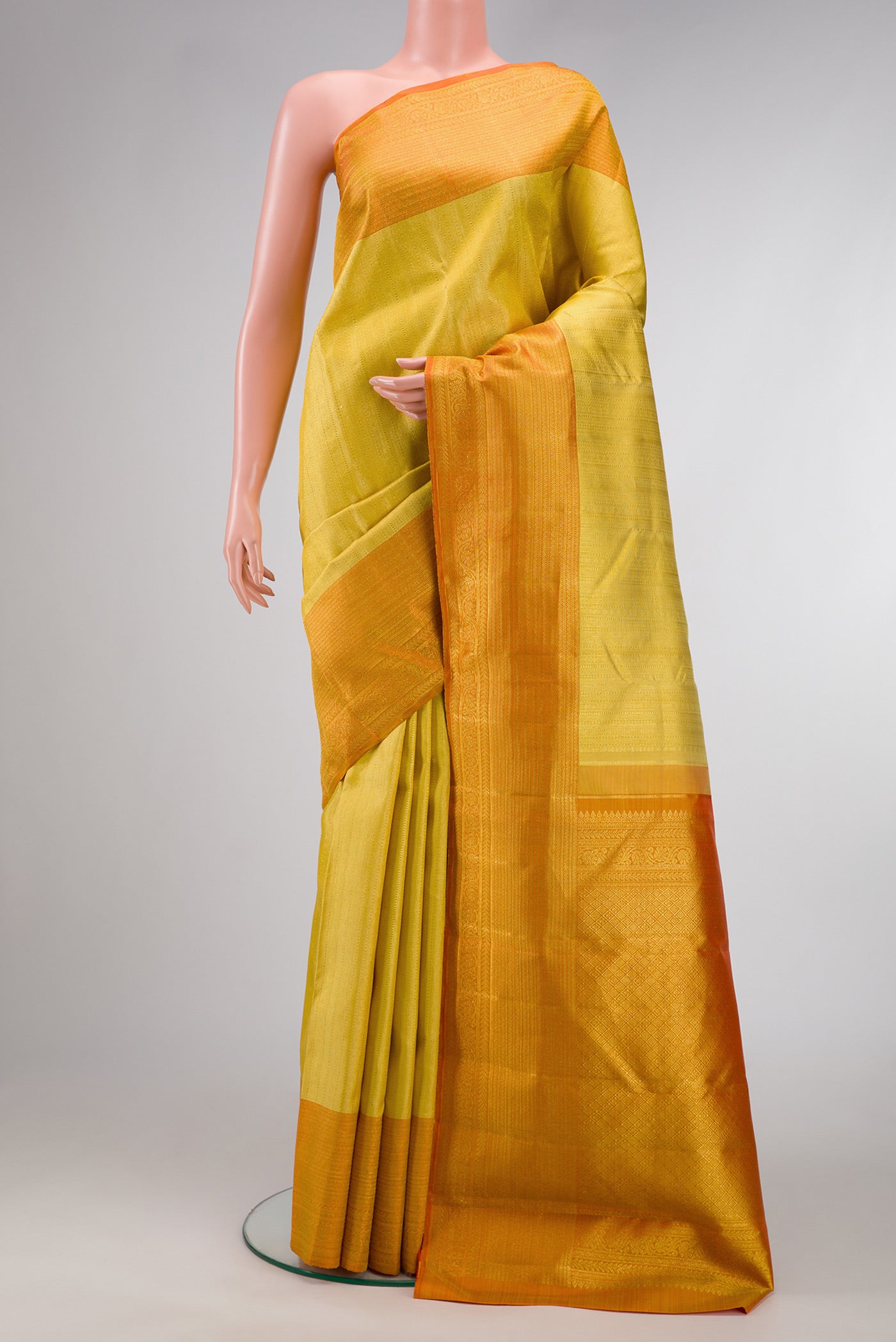 Sandal Dual Tone Kanchipuram Silk Saree with Zari Brocade on the body and Zari Border.  displayed on a mannequin