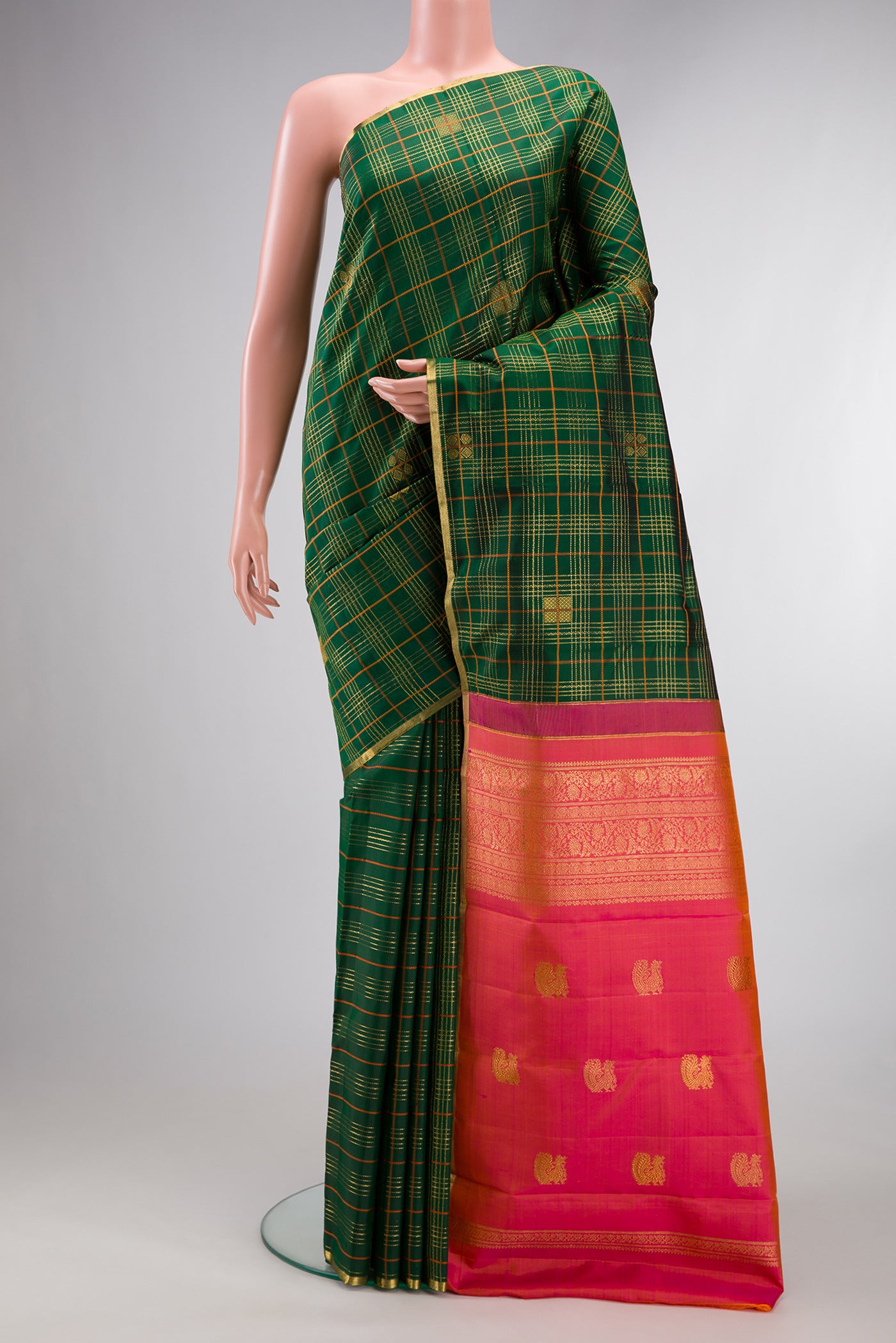 Pure Silk Bottle Green Kanjivaram Saree with Checked design on the body and Zari Border.  displayed on a mannequin