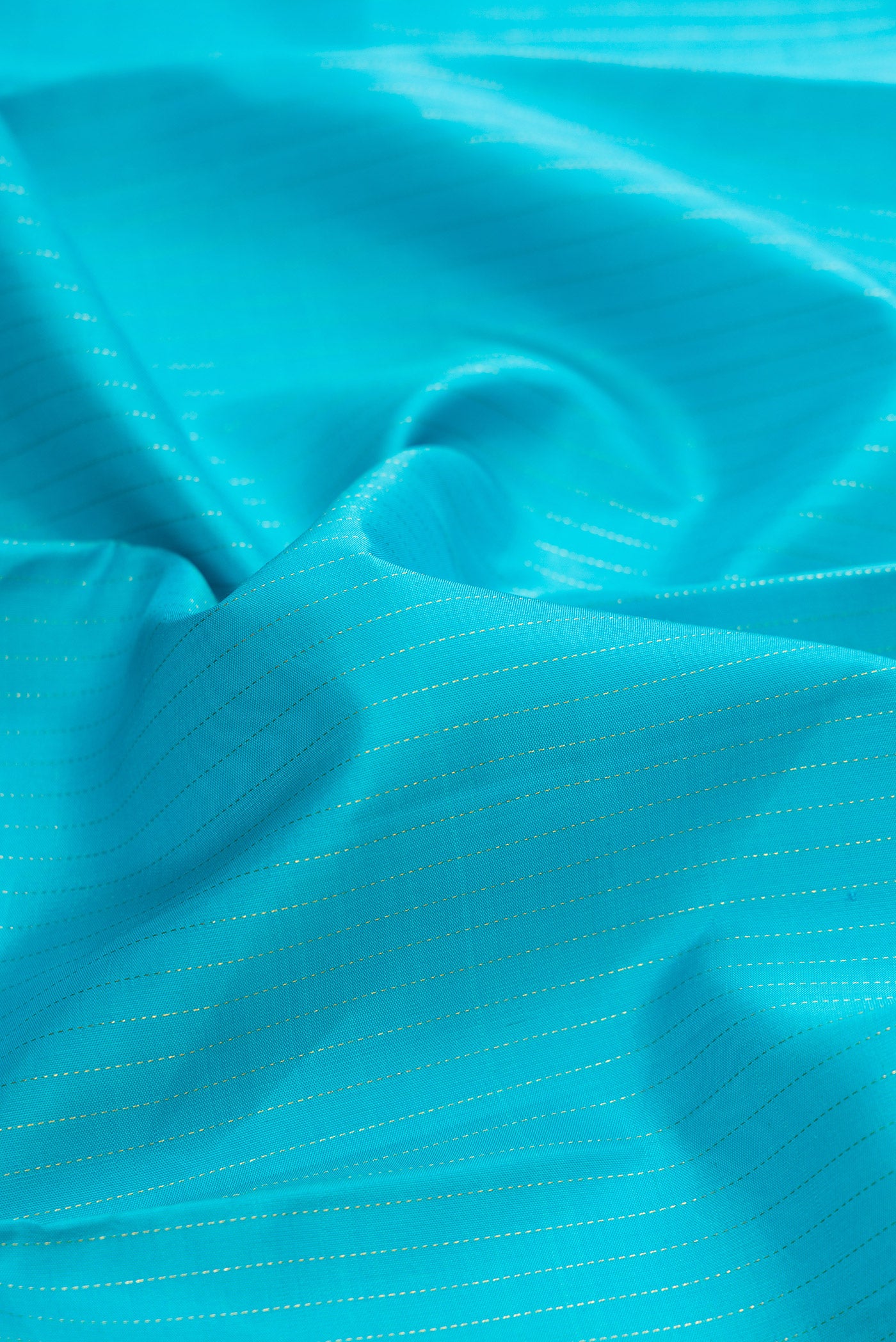 Close up of Sky Blue Dual Tone Kanjivaram Silk Saree with Stripes on the body and Zari Border.  displaying folds