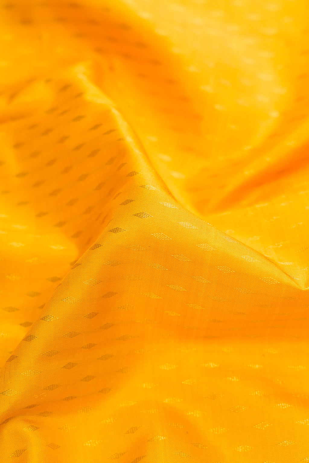Close up of Yellow Dual Tone Kanjivaram Silk Saree with Zari Butta on the body and Zari Border.  displaying folds