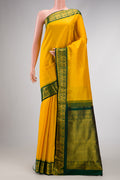 Yellow Dual Tone Kanjivaram Silk Saree with Zari Butta on the body and Zari Border.  displayed on a mannequin