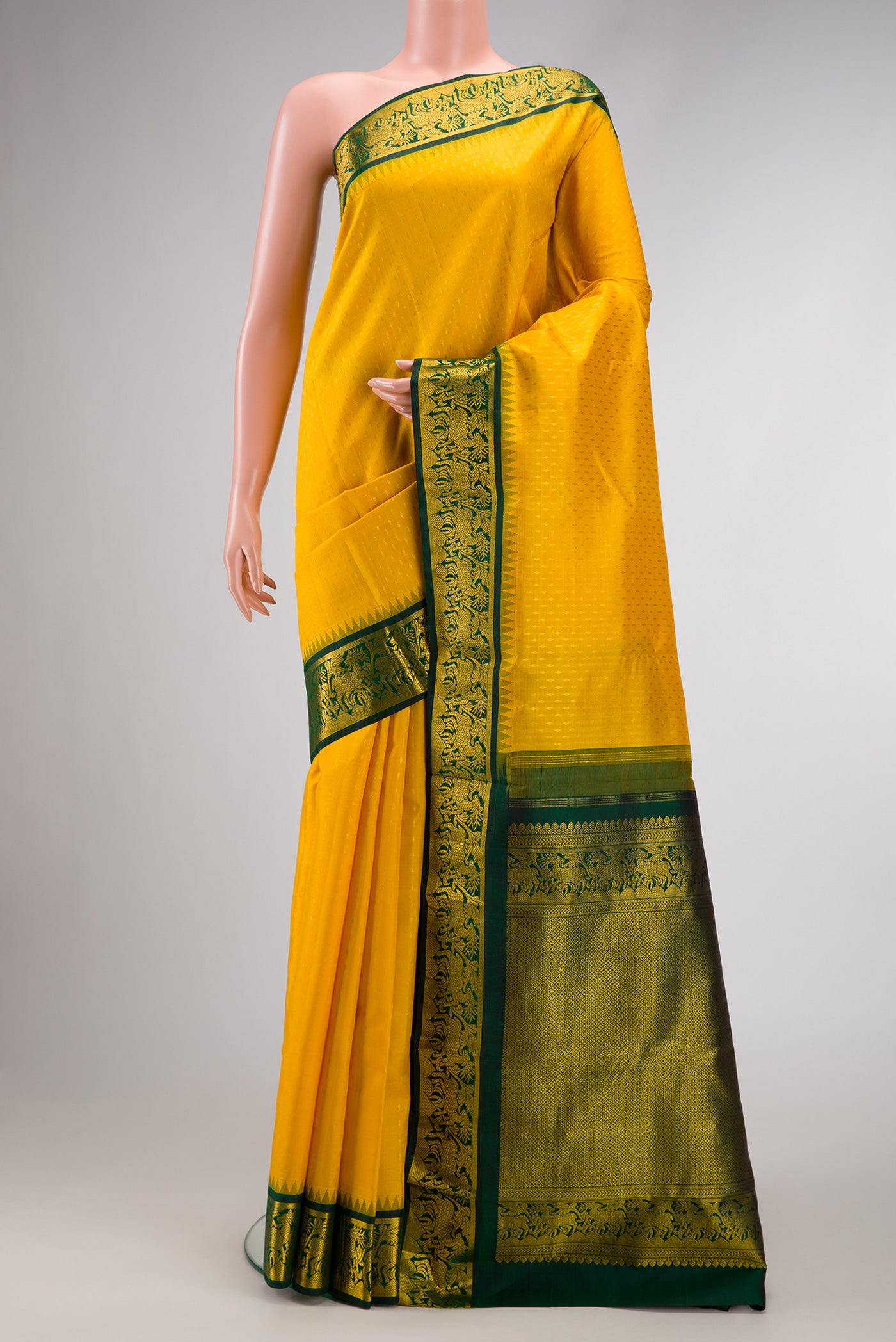 Yellow Dual Tone Kanjivaram Silk Saree with Zari Butta on the body and Zari Border.  displayed on a mannequin