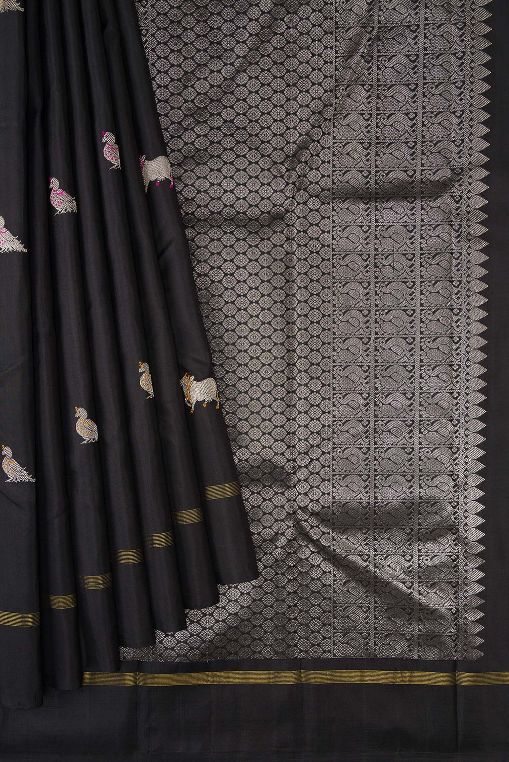 Pleats and pallu of Black Dual Tone Kanjivaram Silk Saree with Zari And Thread Butta on the body and Zari Border. 