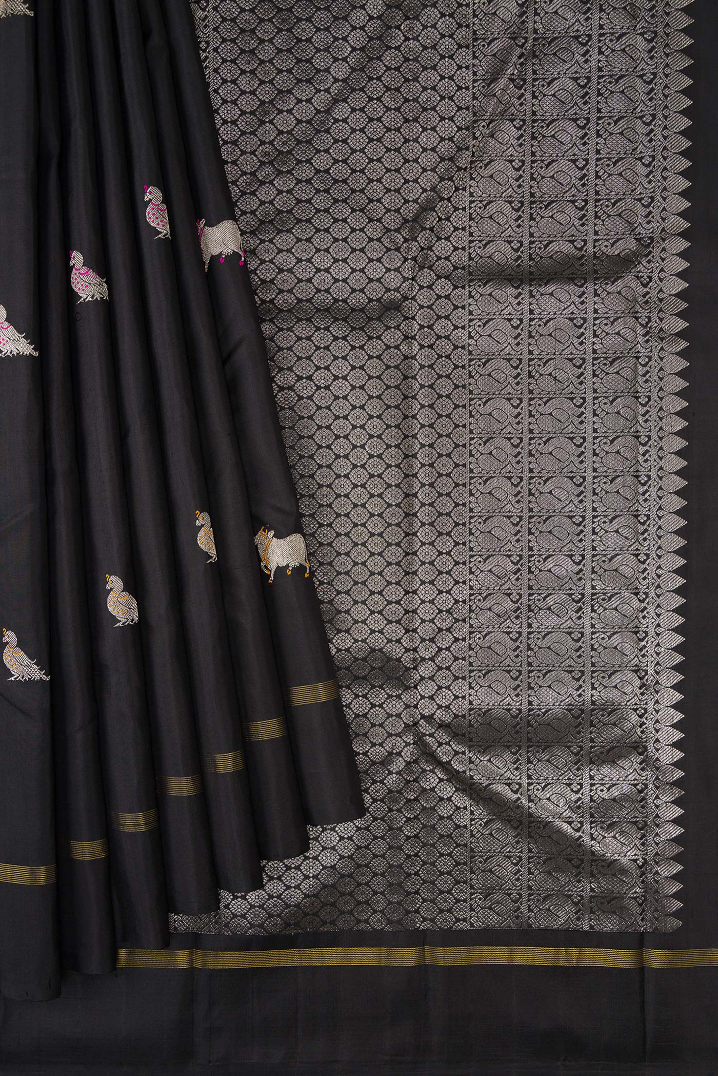 Pleats and pallu of Black Dual Tone Kanjivaram Silk Saree with Zari And Thread Butta on the body and Zari Border. 