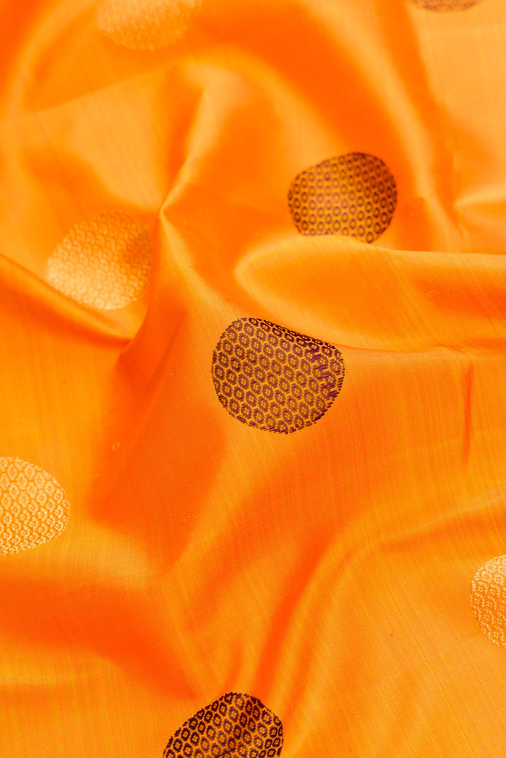 Close up of Pure Silk Pure Zari Mustard Dual Tone Kanchipuram Saree with Zari And Thread Butta on the body and Zari And Thread Border.  displaying folds