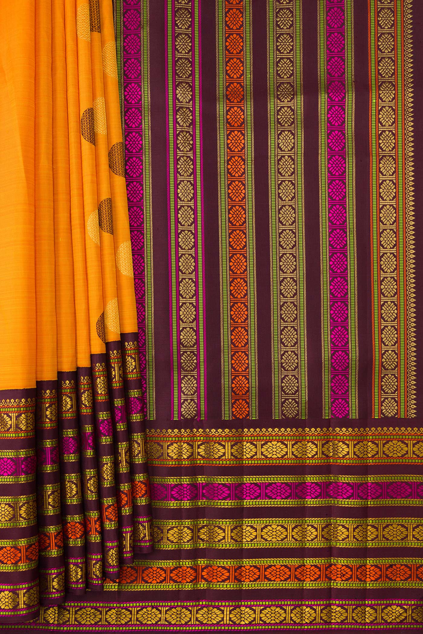 Pleats and pallu of Pure Silk Pure Zari Mustard Dual Tone Kanchipuram Saree with Zari And Thread Butta on the body and Zari And Thread Border. 