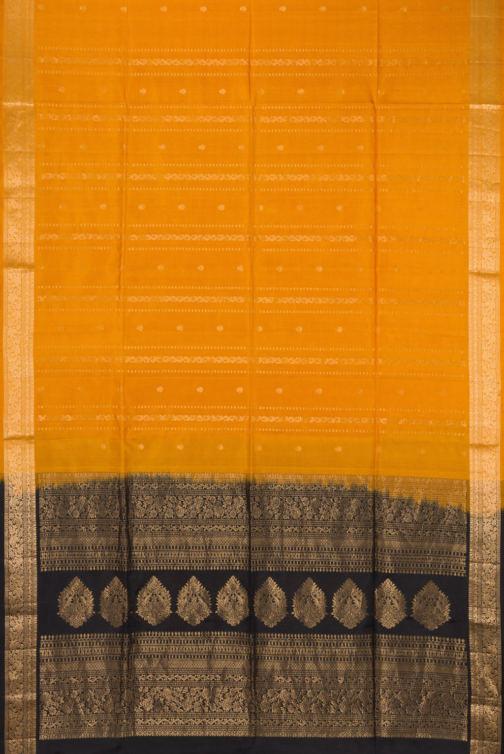 Flat view of Mustard Soft Silk Saree with Zari Butta on the body and Zari Border. 
