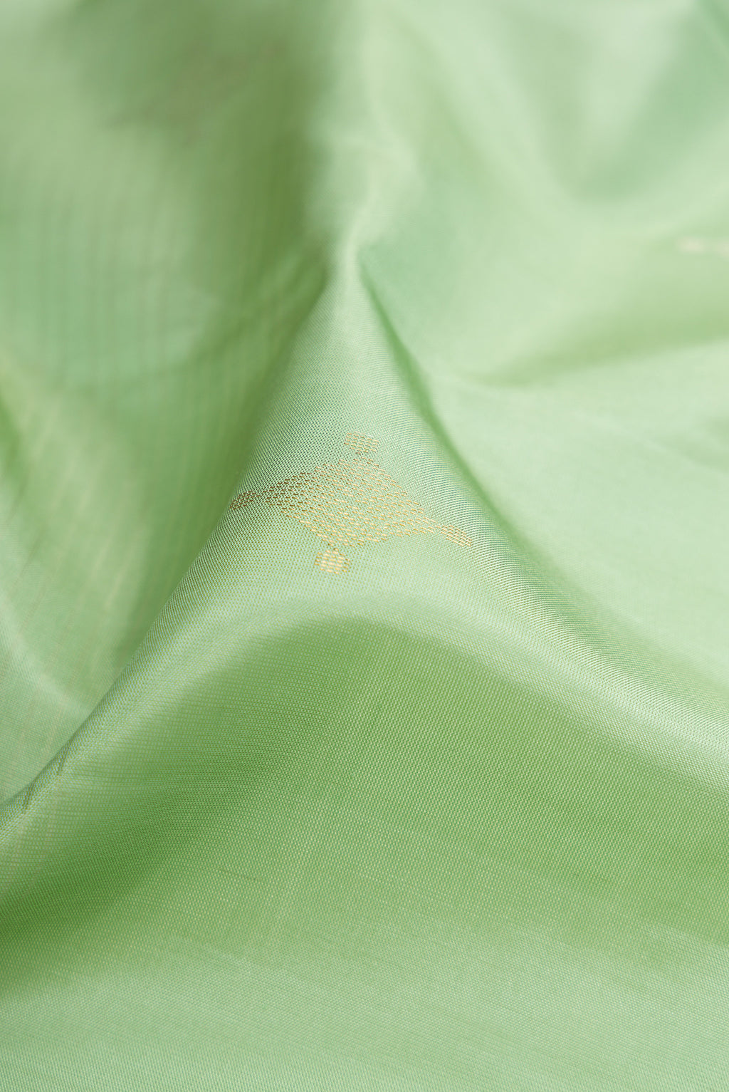 Close up of Pista Green Soft Silk Saree with Stripes on the body and Without Border.  displaying folds