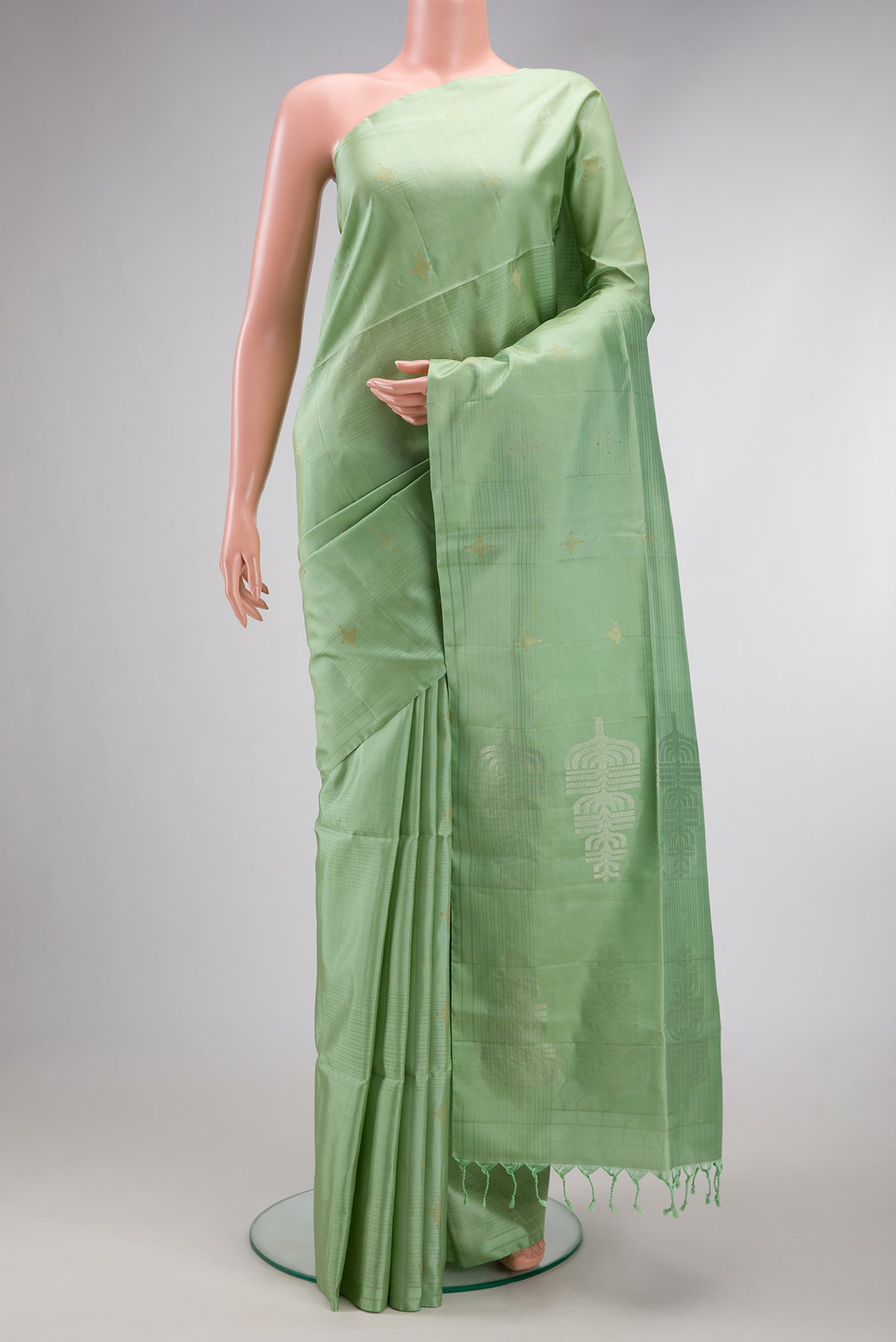 Pista Green Soft Silk Saree with Stripes on the body and Without Border.  displayed on a mannequin