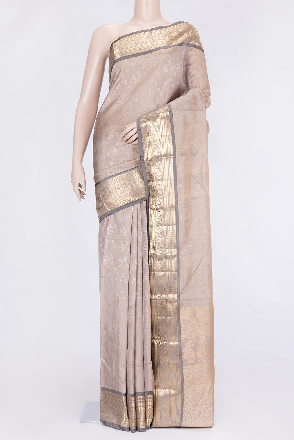 Beige Dual Tone Kanchipuram Silk Saree with Jacquard design on the body and Zari Border.  displayed on a mannequin