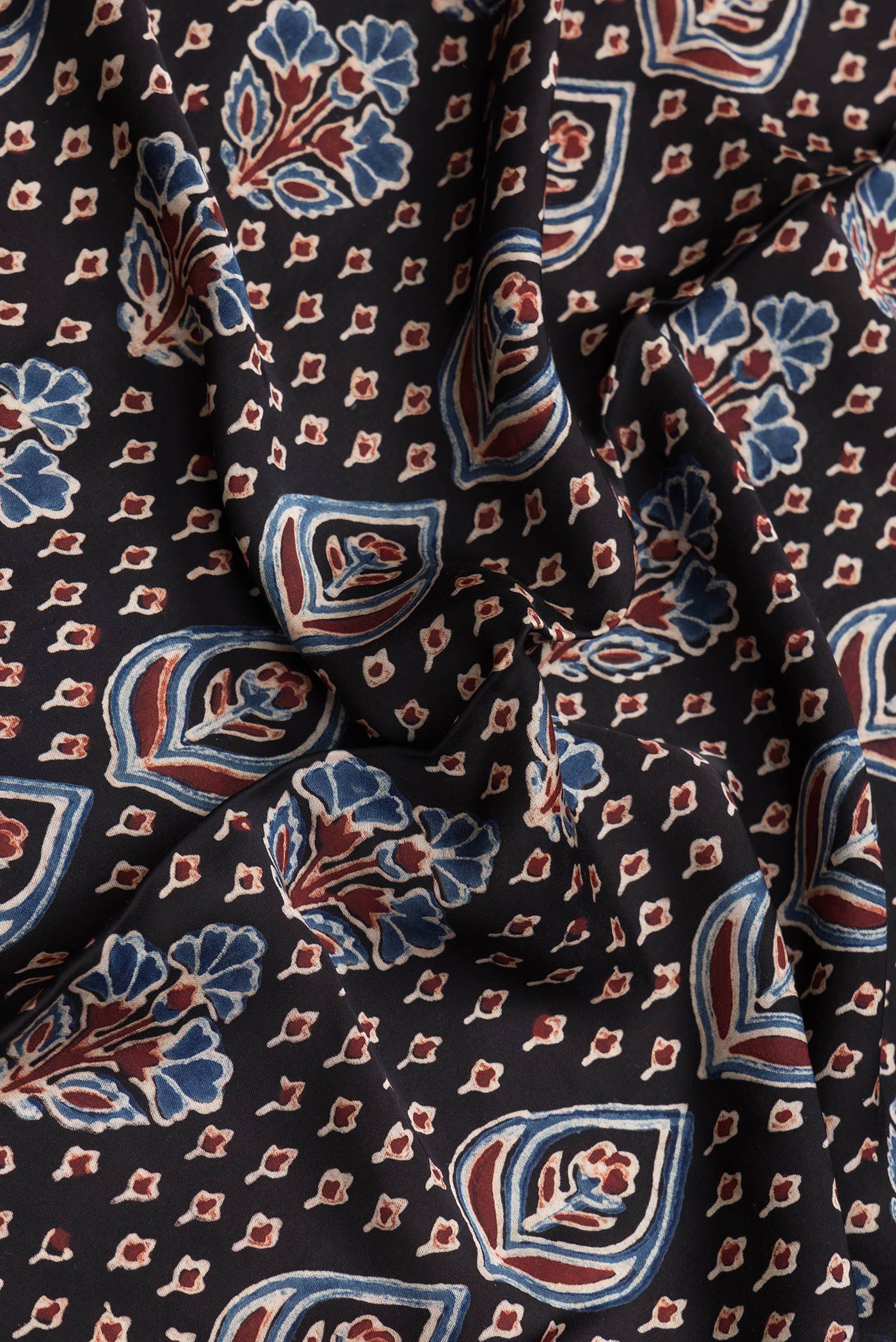 Close up of Brown Dual Tone Blended Satin Crepe Saree with Printed design on the body and Printed Border.  displaying folds