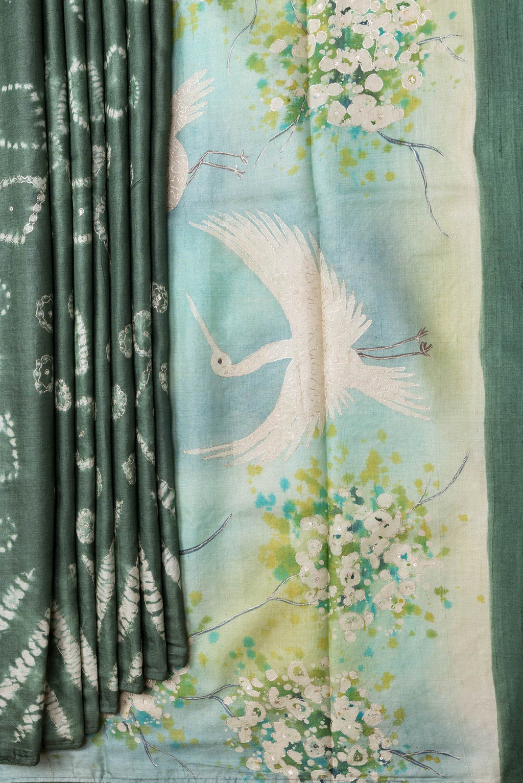 Pleats and pallu of Mehandi Green Dual Tone Tussar Silk Saree with Embroidery on the body and Without Border. 