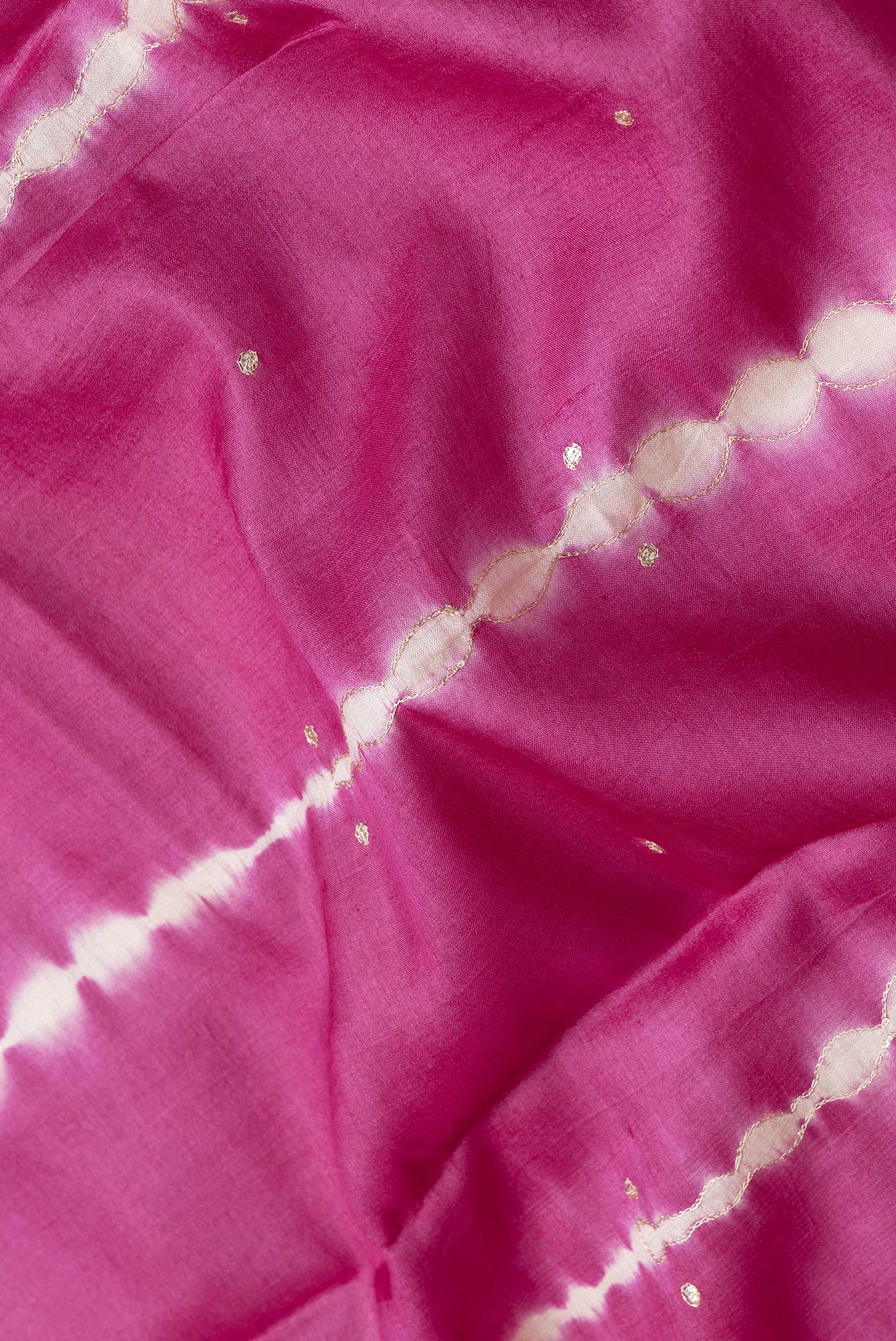 Close up of Pink Dual Tone Tussar Silk Saree with Embroidery on the body and Without Border.  displaying folds