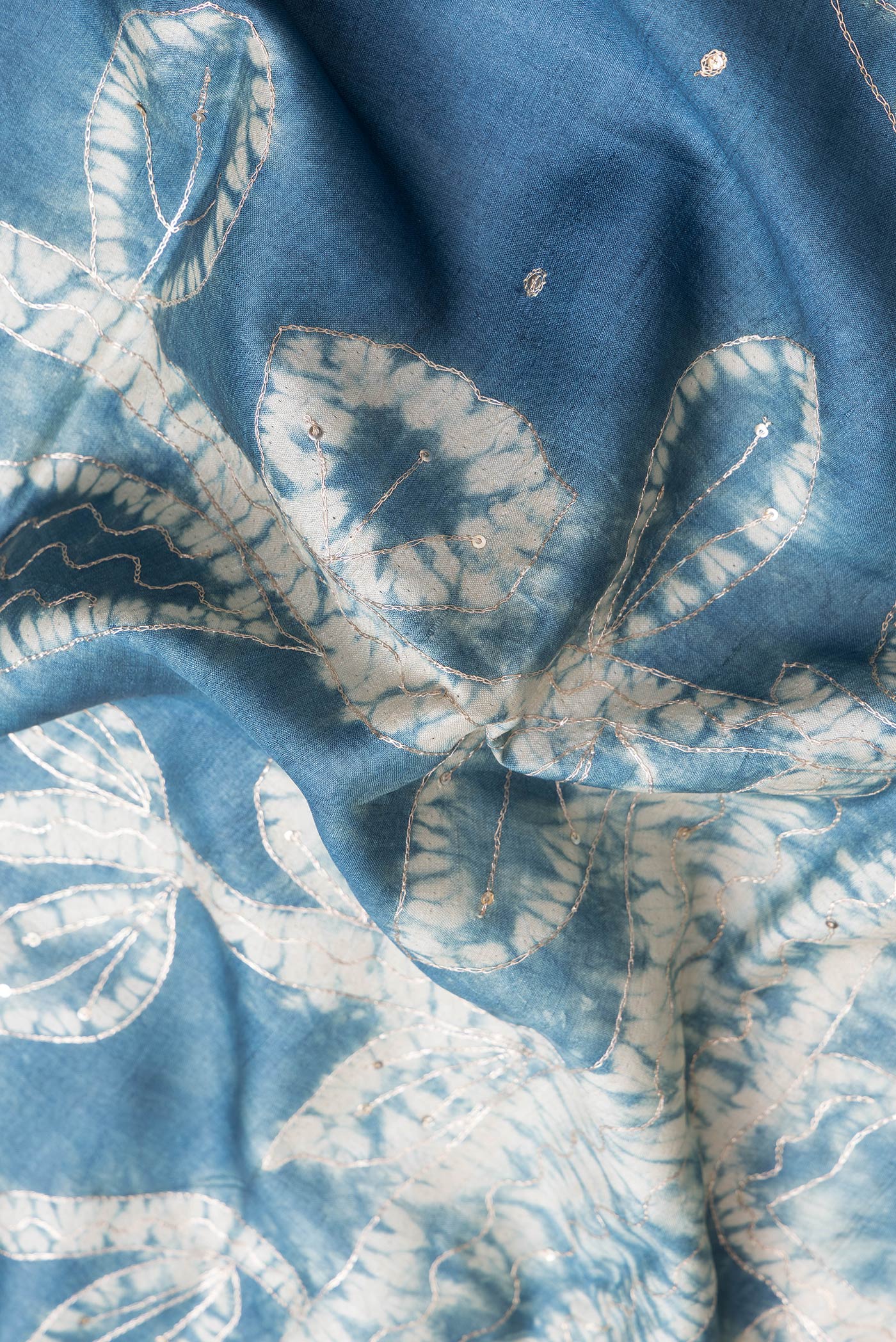 Close up of Grey Dual Tone Tussar Silk Saree with Embroidery on the body and Fancy Border.  displaying folds