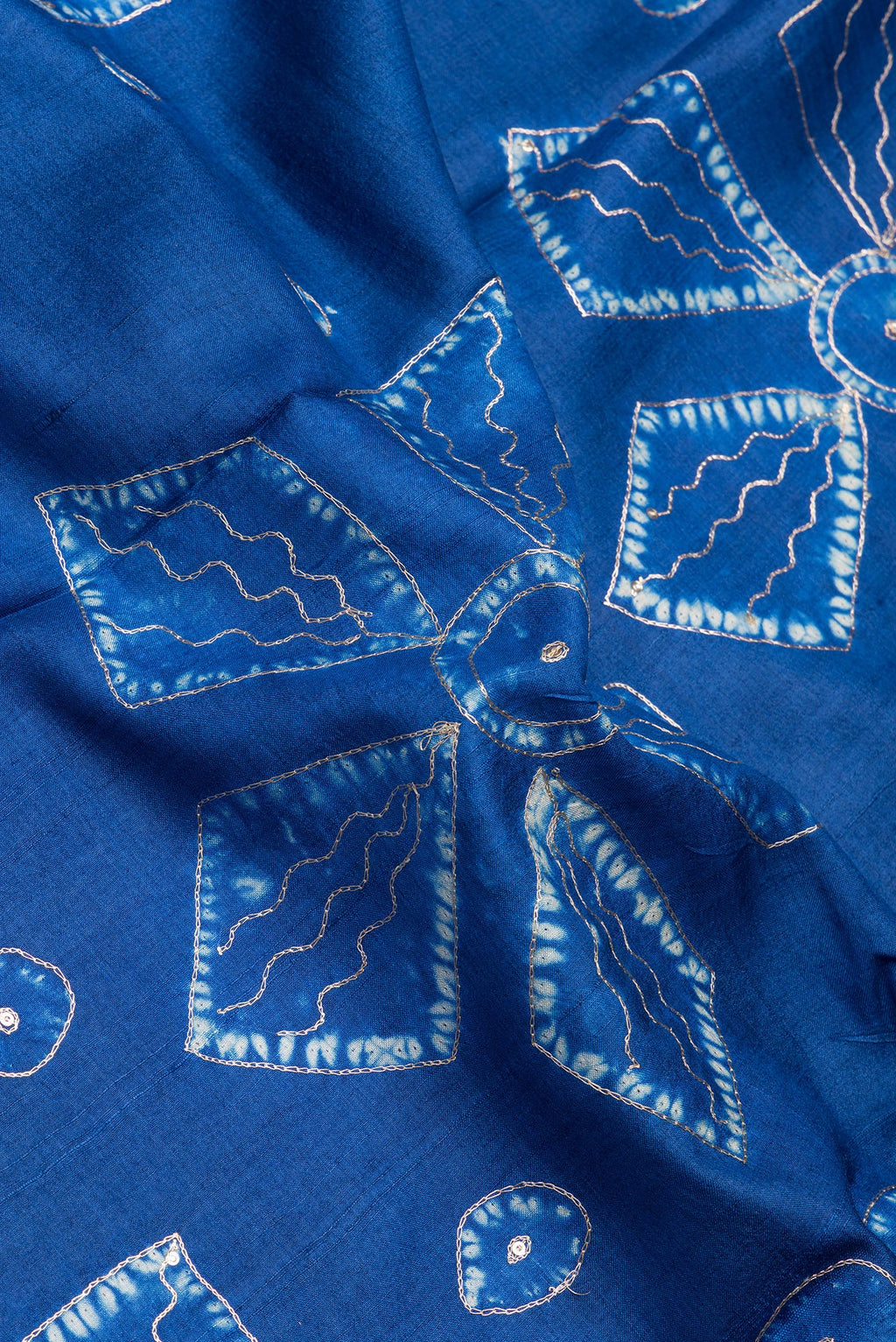 Close up of Royal Blue Tussar Silk Saree with Embroidery on the body and Fancy Border.  displaying folds