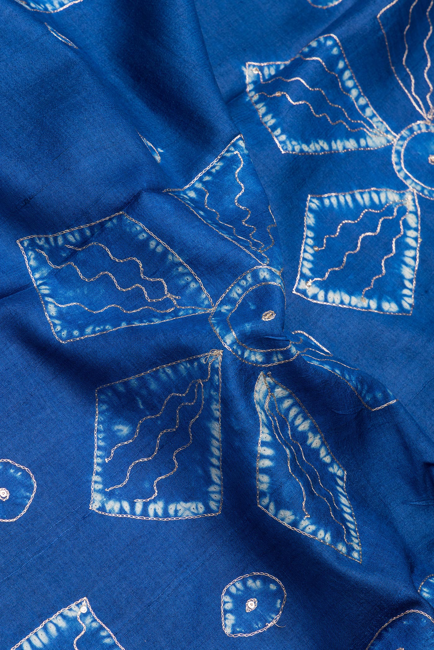 Close up of Royal Blue Tussar Silk Saree with Embroidery on the body and Fancy Border.  displaying folds