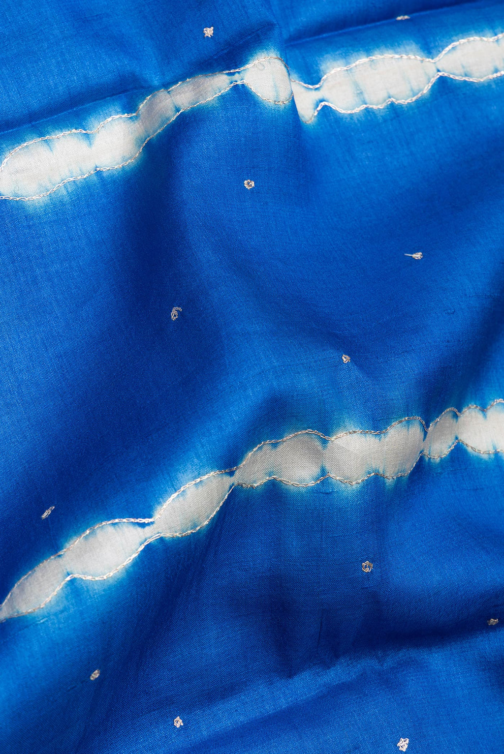 Close up of Royal Blue Tussar Silk Saree with Embroidery on the body and Fancy Border.  displaying folds
