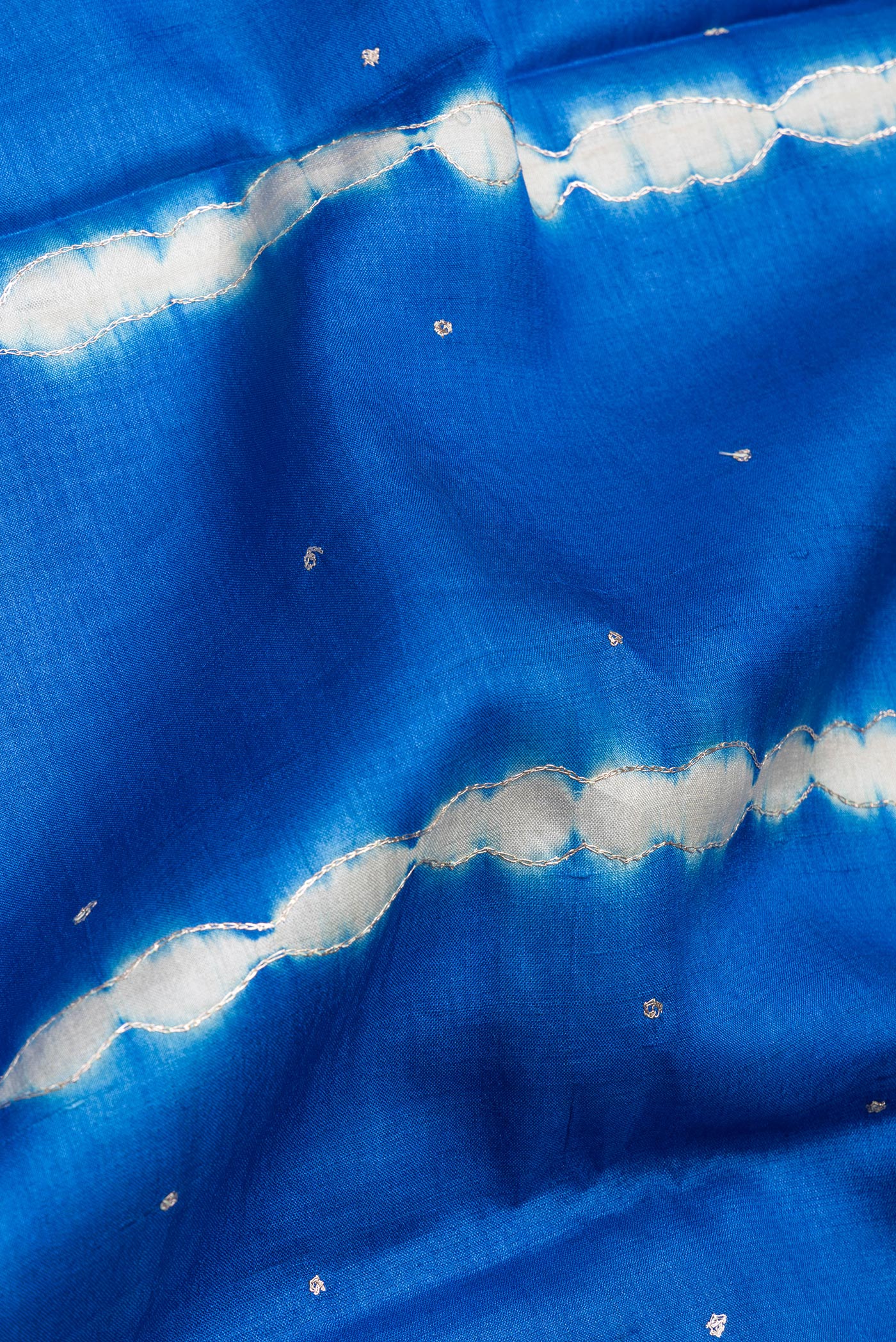 Close up of Royal Blue Tussar Silk Saree with Embroidery on the body and Fancy Border.  displaying folds