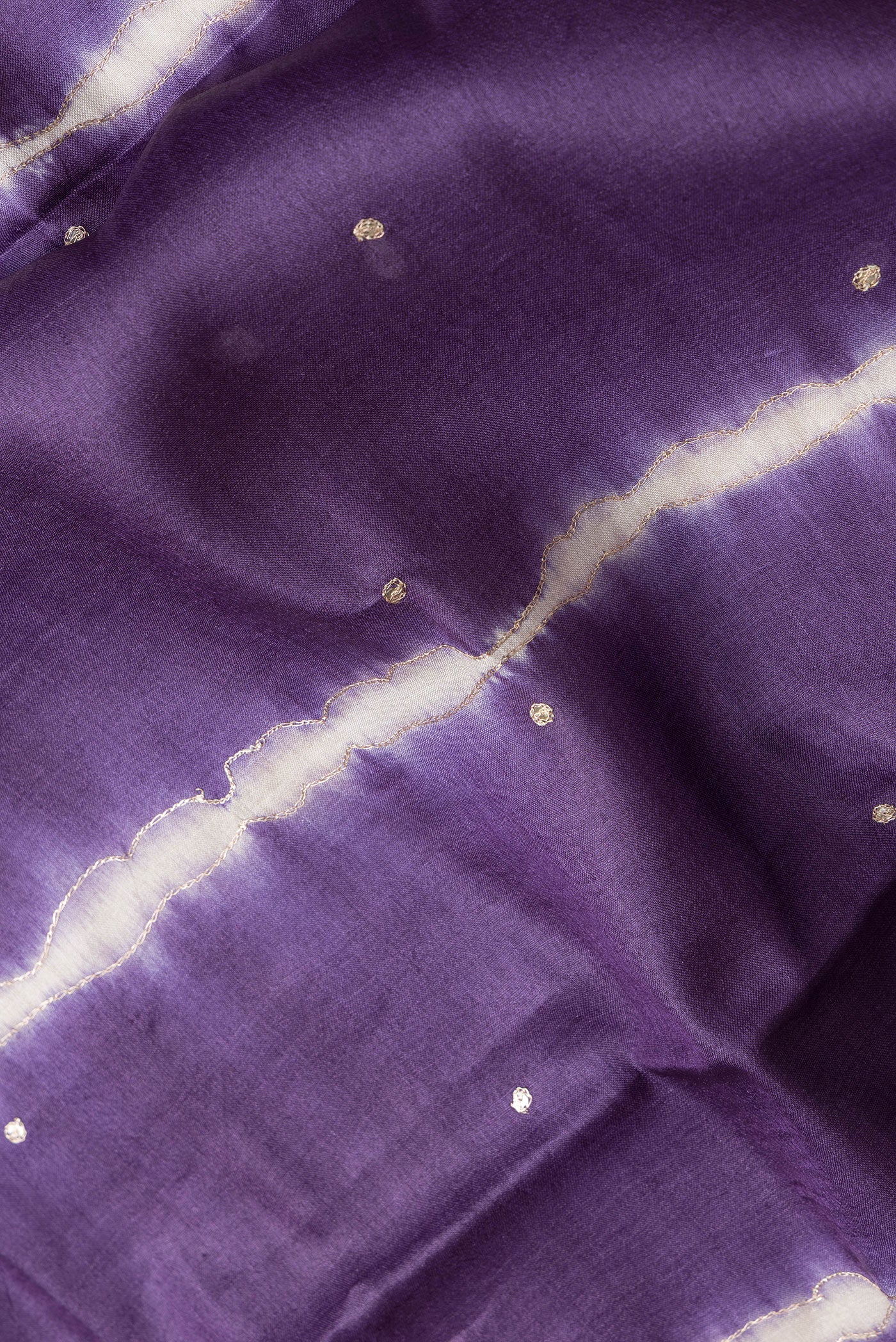 Close up of Purple Dual Tone Tussar Silk Saree with Embroidery on the body and Without Border.  displaying folds