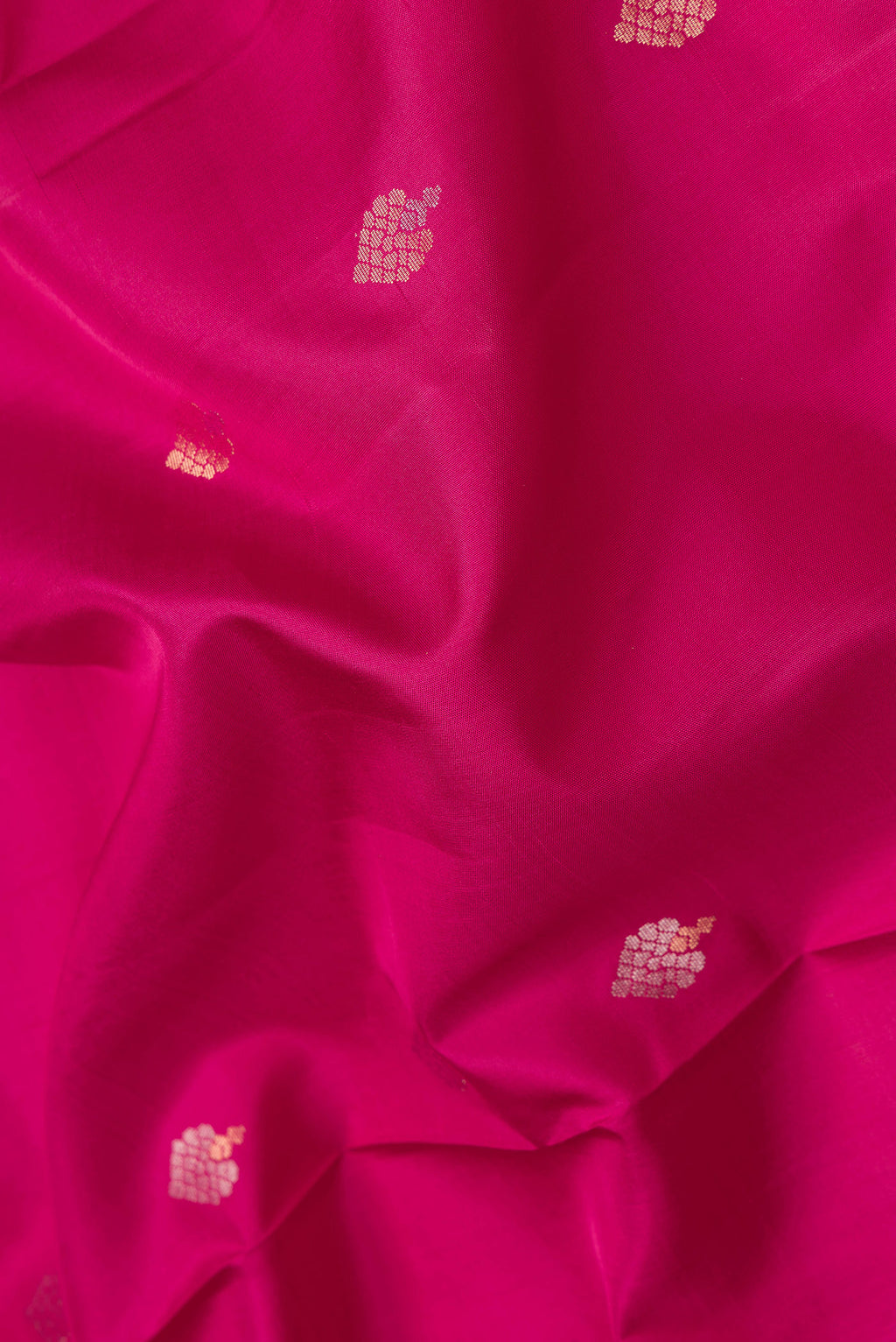 Close up of Dark Pink Dual Tone Soft Silk Saree with Zari Butta on the body and Zari Border.  displaying folds