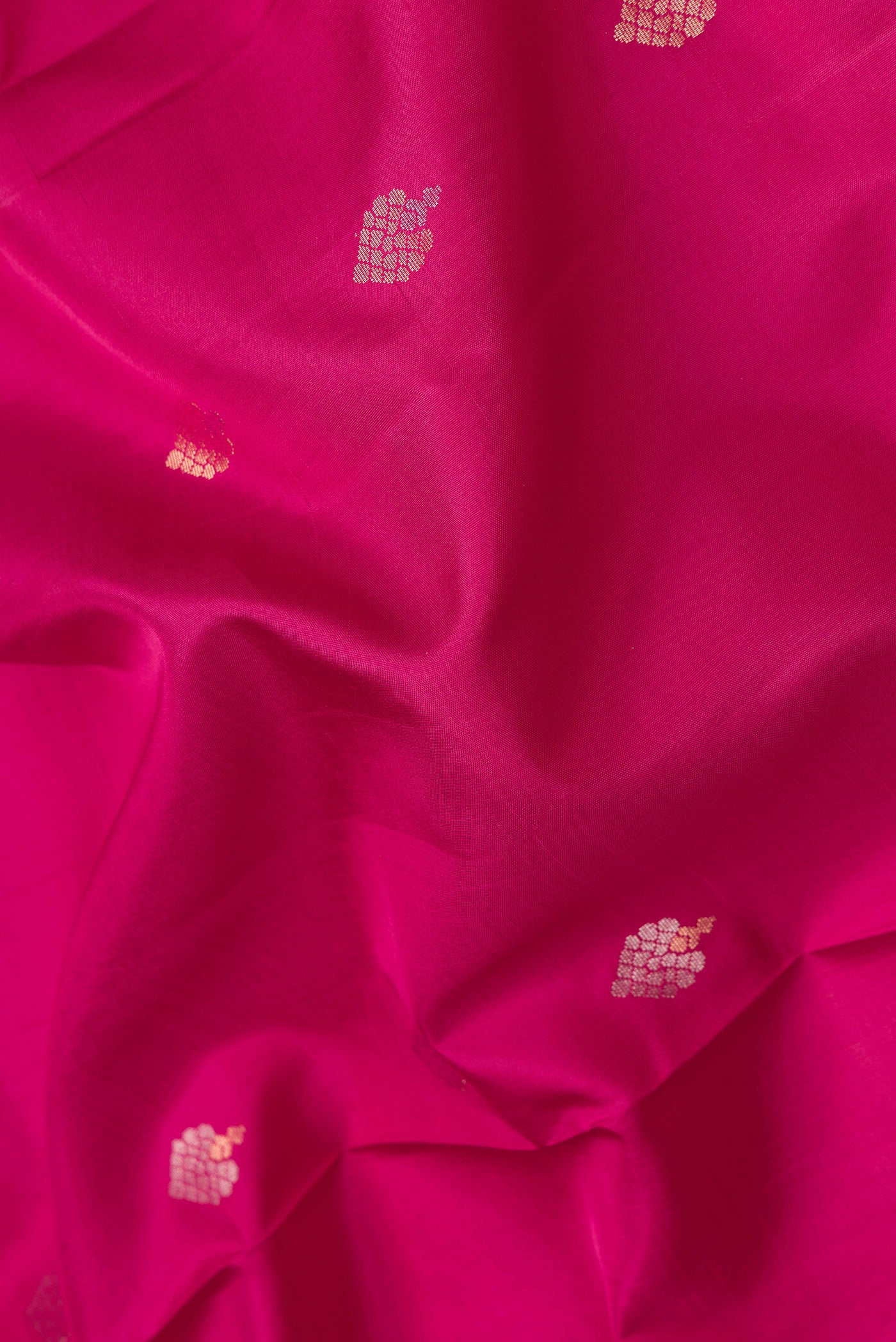 Close up of Dark Pink Dual Tone Soft Silk Saree with Zari Butta on the body and Zari Border.  displaying folds