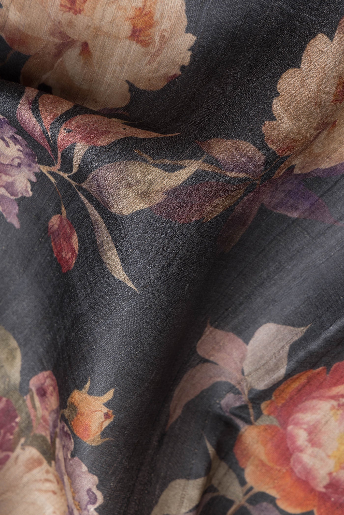 Close up of Black Dual Tone Tussar Silk Saree with Printed design on the body and Without Border.  displaying folds