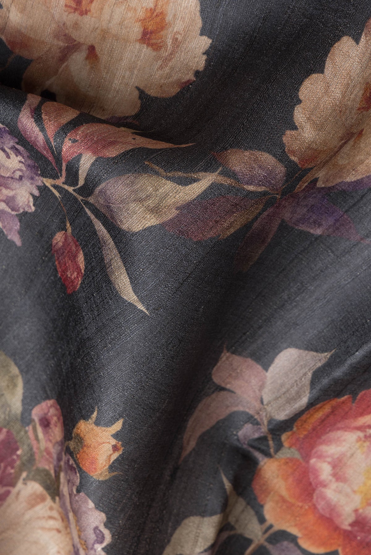 Close up of Black Dual Tone Tussar Silk Saree with Printed design on the body and Without Border.  displaying folds