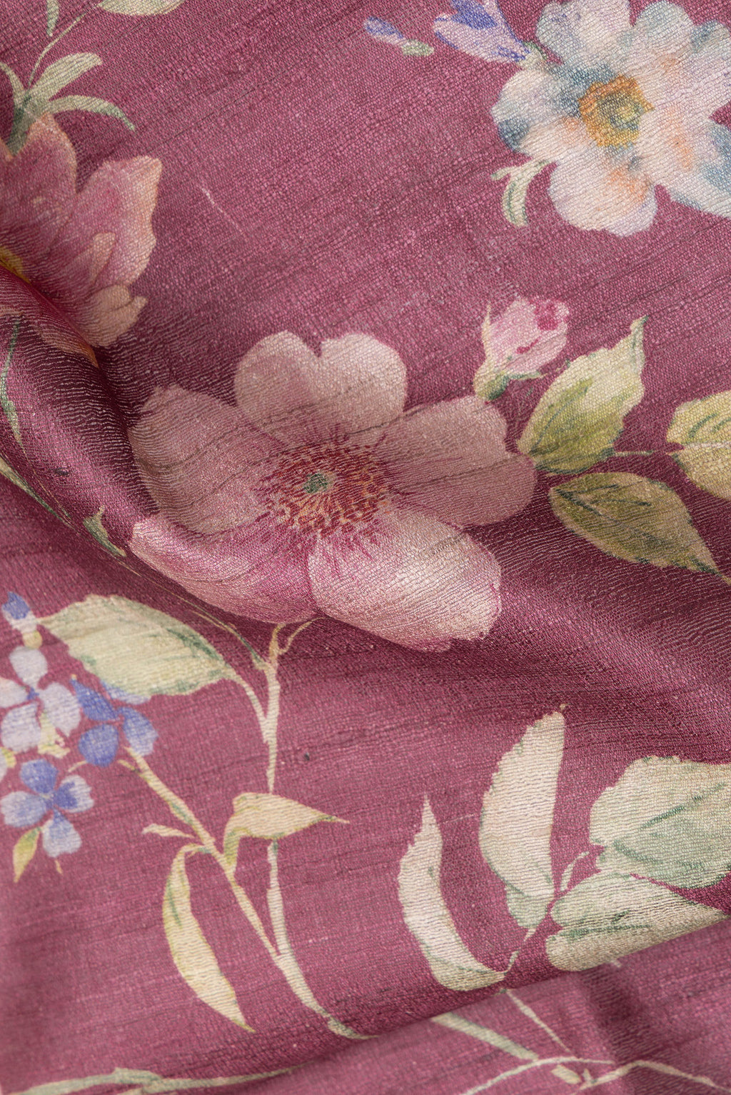 Close up of Maroon Dual Tone Tussar Silk Saree with Printed design on the body and Zari Border.  displaying folds